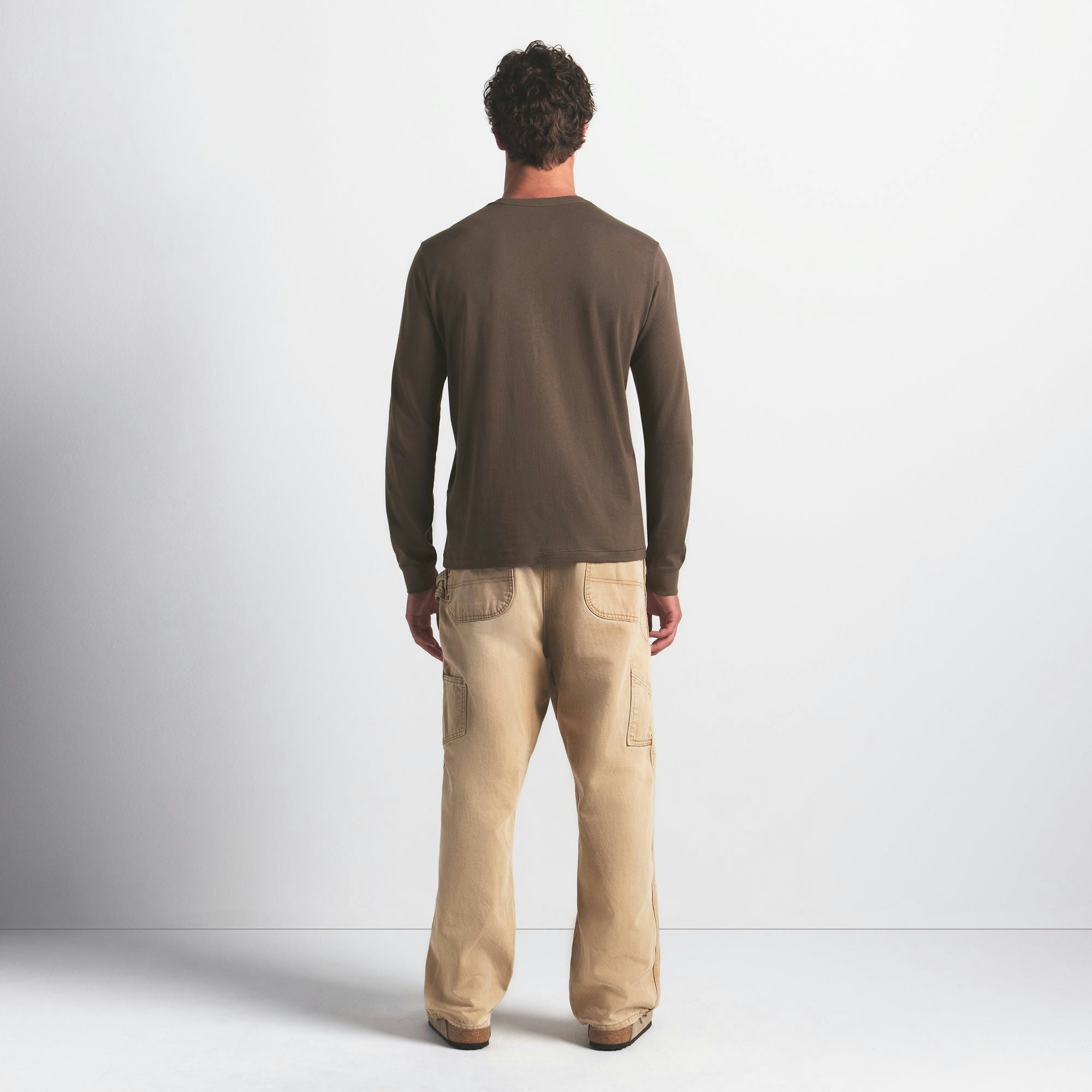 SKIMS COTTON MENS CLASSIC LONG SLEEVE T-SHIRT | DRIFTWOOD ON A MODEL FRONT VIEW @ | FOCUS: 0.0, 1.0, 0.9