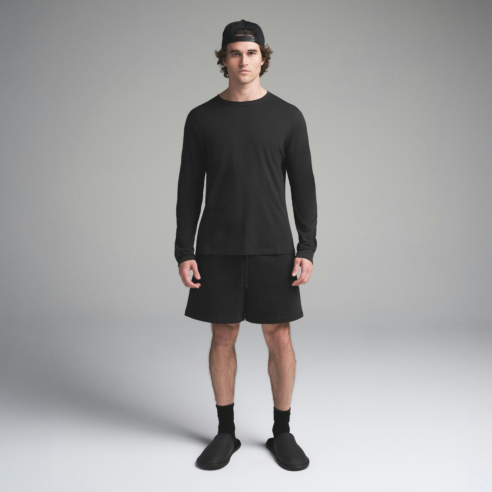 SKIMS COTTON MENS CLASSIC LONG SLEEVE T-SHIRT | ONYX ON A MODEL FRONT VIEW | FOCUS: 0.0, 1.0, 0.9
