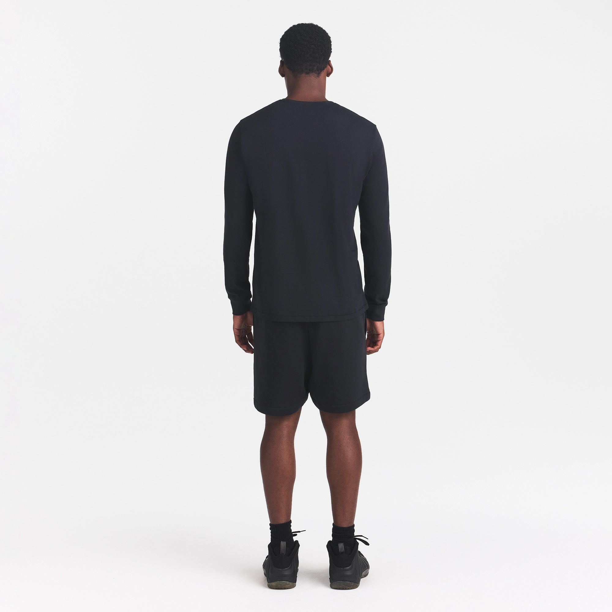 SKIMS COTTON MENS CLASSIC LONG SLEEVE T-SHIRT | ONYX ON A MODEL BACK VIEW