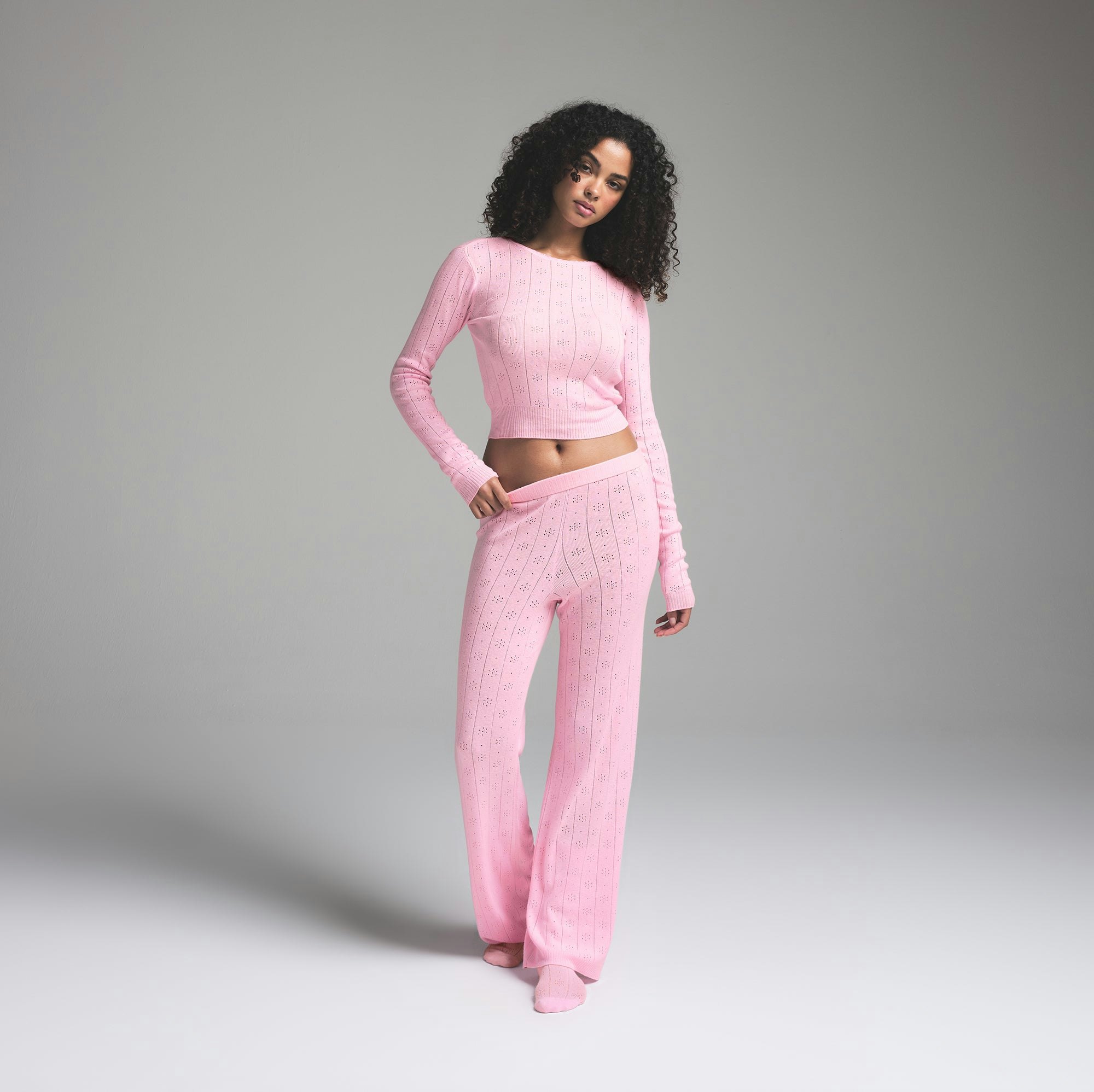SWEATER POINTELLE LONG SLEEVE TOP | BABY PINK ON A MODEL FRONT VIEW | FOCUS: 0.0, 1.0, 0.9