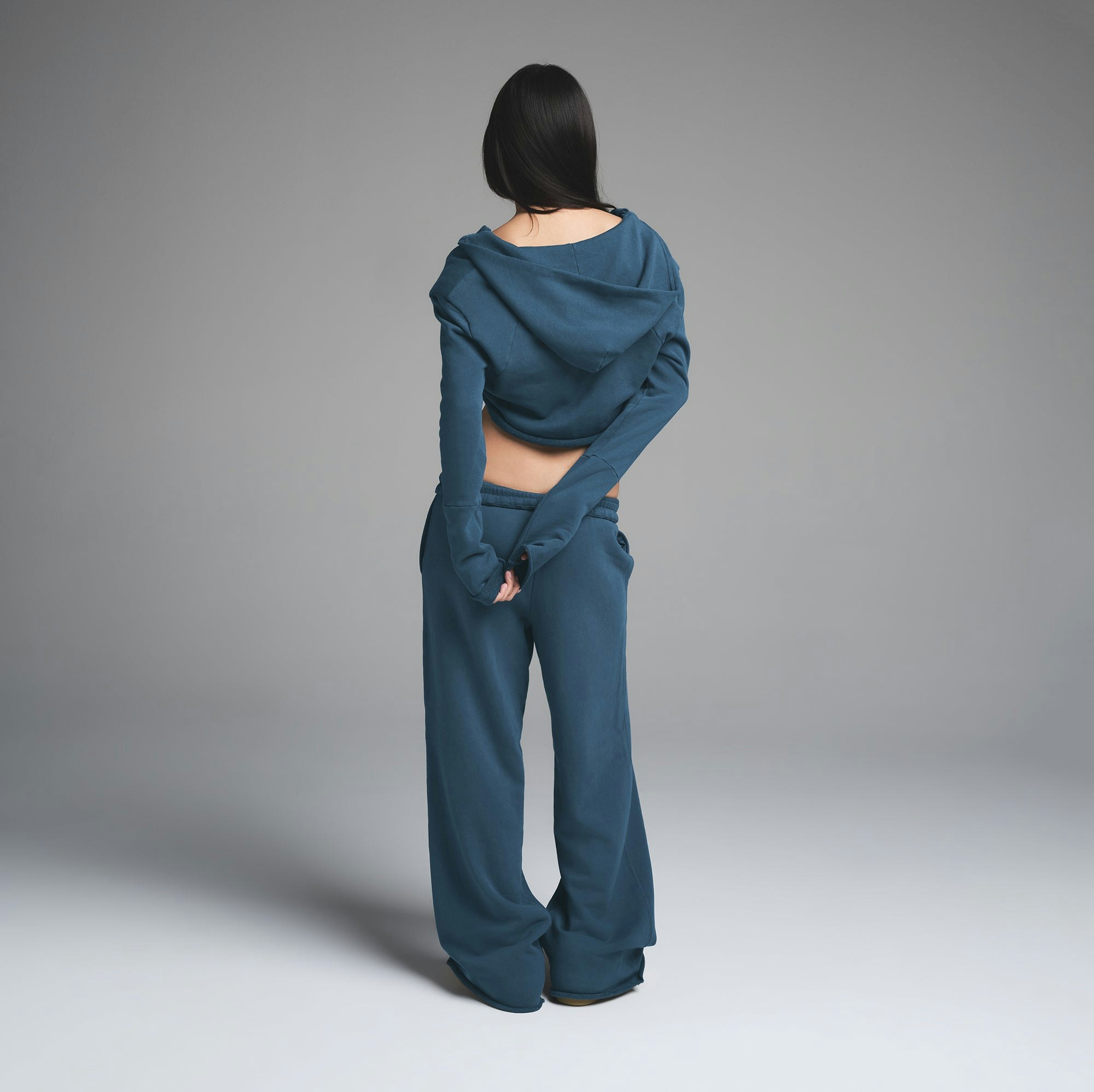 FRENCH TERRY SHOULDER PAD CROPPED HOODIE | INDIGO ON A MODEL BACK VIEW | FOCUS: 0.0, 1.0, 0.9