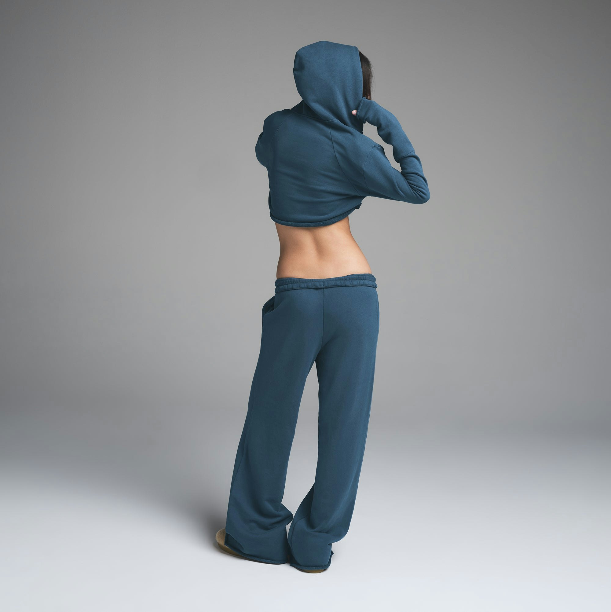FRENCH TERRY SHOULDER PAD CROPPED HOODIE | INDIGO ON A MODEL BACK VIEW | FOCUS: 0.0, 1.0, 0.9