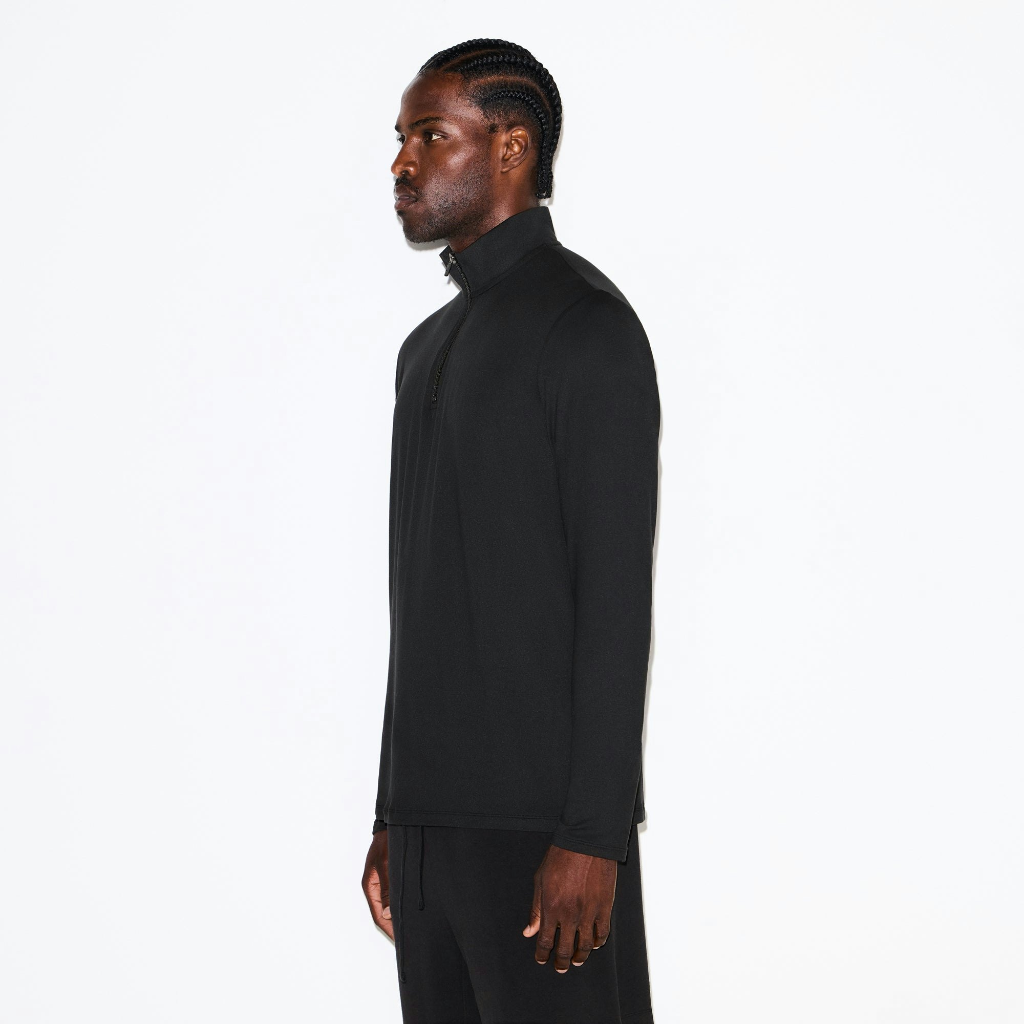 OUTDOOR JERSEY MENS HALF ZIP TOP | ONYX ON A MODEL SIDE VIEW @ | FOCUS: 0.0, 1.0, 0.9