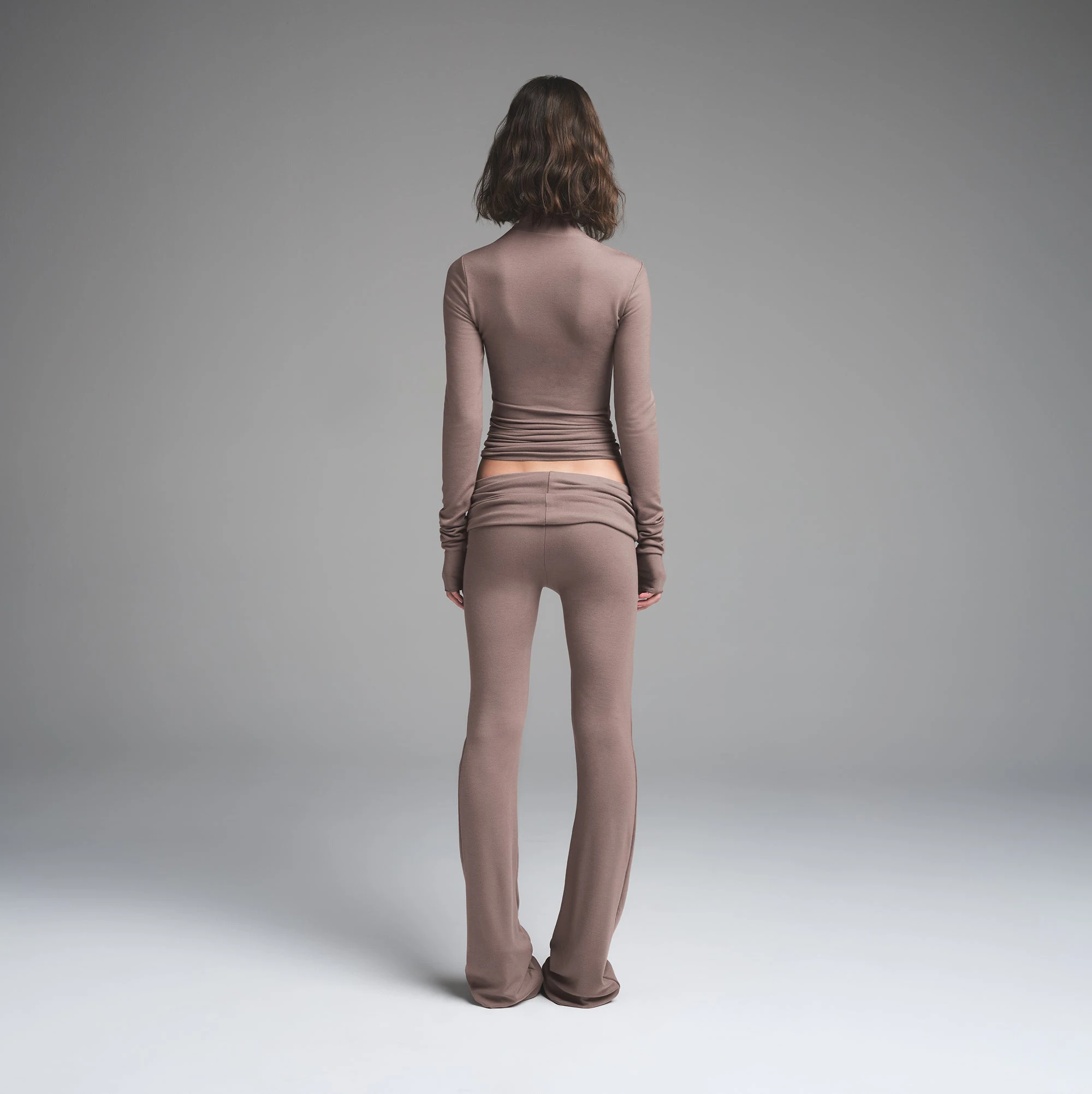 SKIMS CLOUD ASYMMETRIC LONG SLEEVE TOP | AMETHYST ON A MODEL BACK VIEW | FOCUS: 0.0, 1.0, 0.9