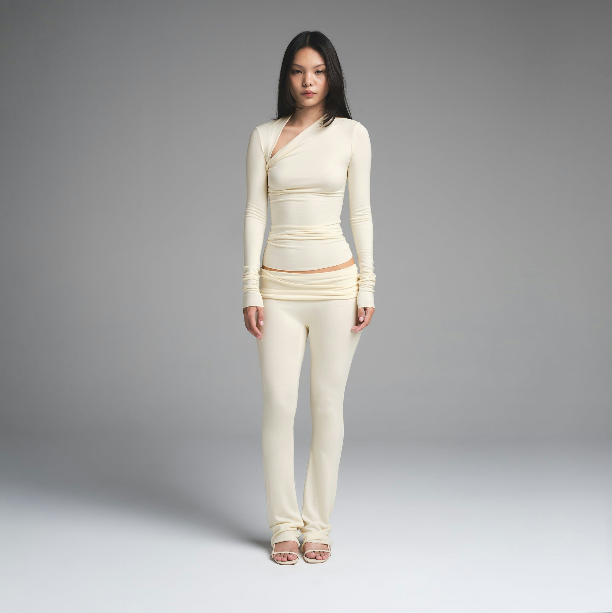 SKIMS CLOUD ASYMMETRIC LONG SLEEVE TOP | ECRU ON A MODEL FRONT VIEW | FOCUS: 0.0, 1.0, 0.9