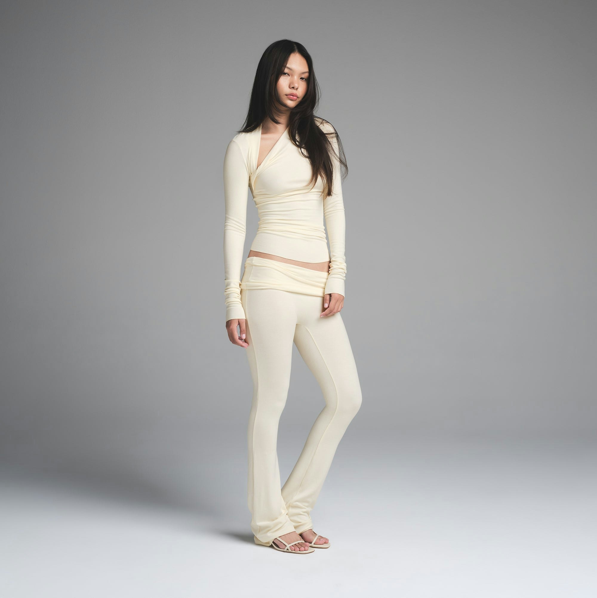 SKIMS CLOUD ASYMMETRIC LONG SLEEVE TOP | ECRU ON A MODEL FRONT VIEW | FOCUS: 0.0, 1.0, 0.9
