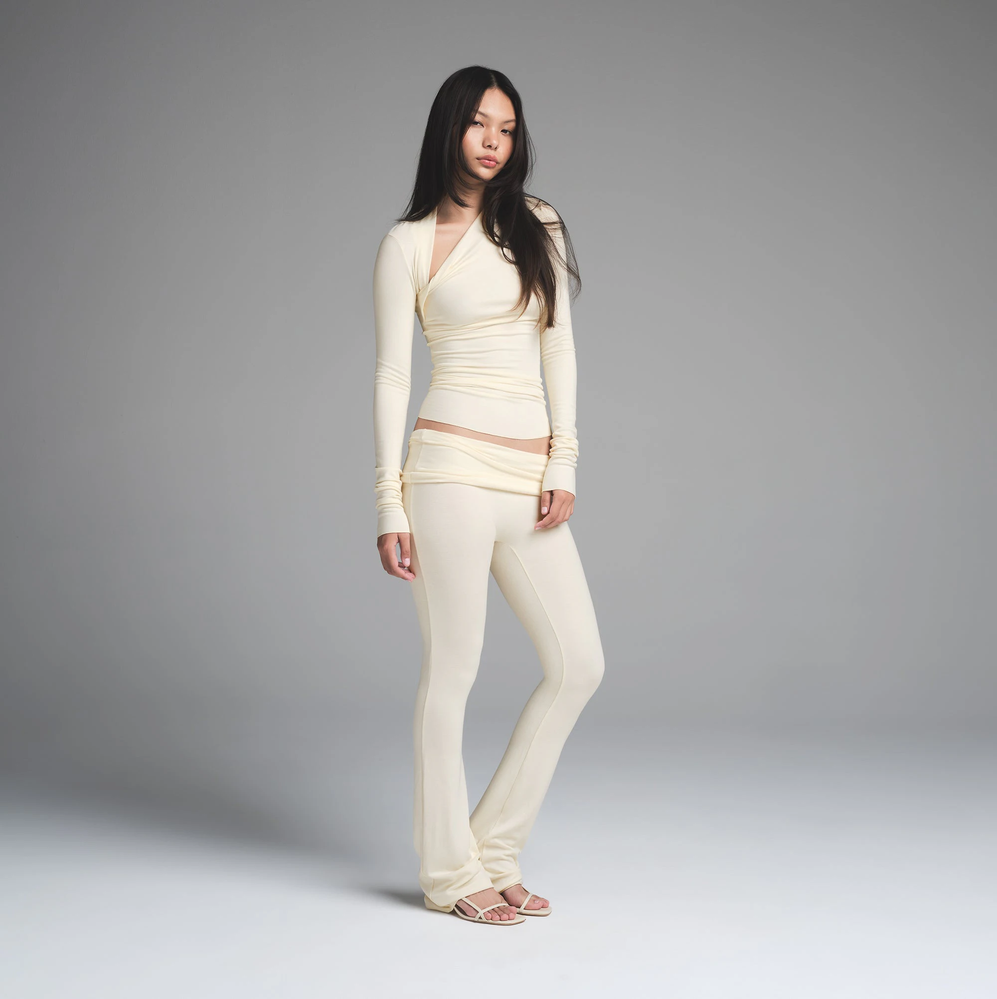 SKIMS CLOUD ASYMMETRIC LONG SLEEVE TOP | ECRU ON A MODEL FRONT VIEW | FOCUS: 0.0, 1.0, 0.9