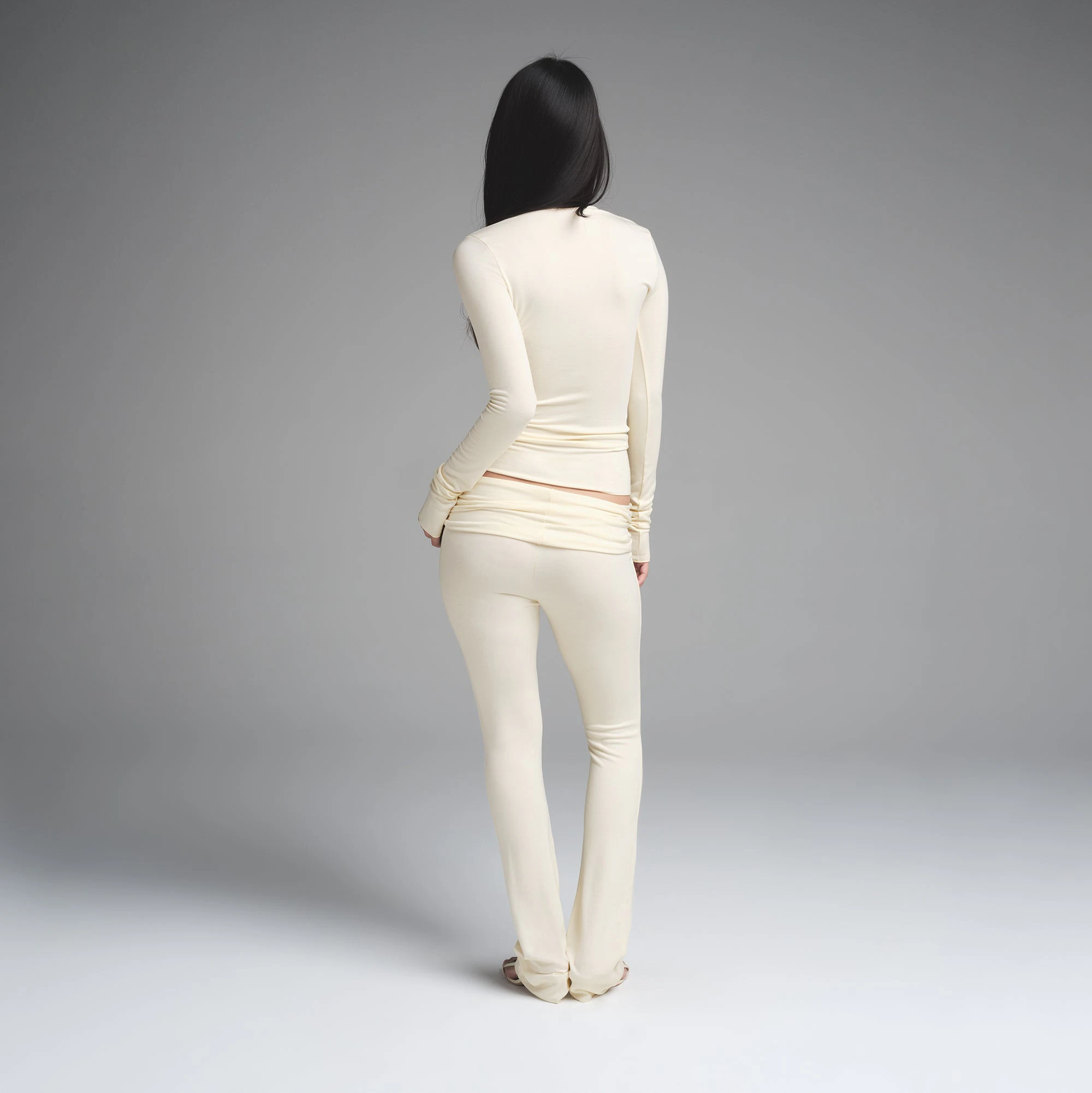 SKIMS CLOUD ASYMMETRIC LONG SLEEVE TOP | ECRU ON A MODEL BACK VIEW | FOCUS: 0.0, 1.0, 0.9