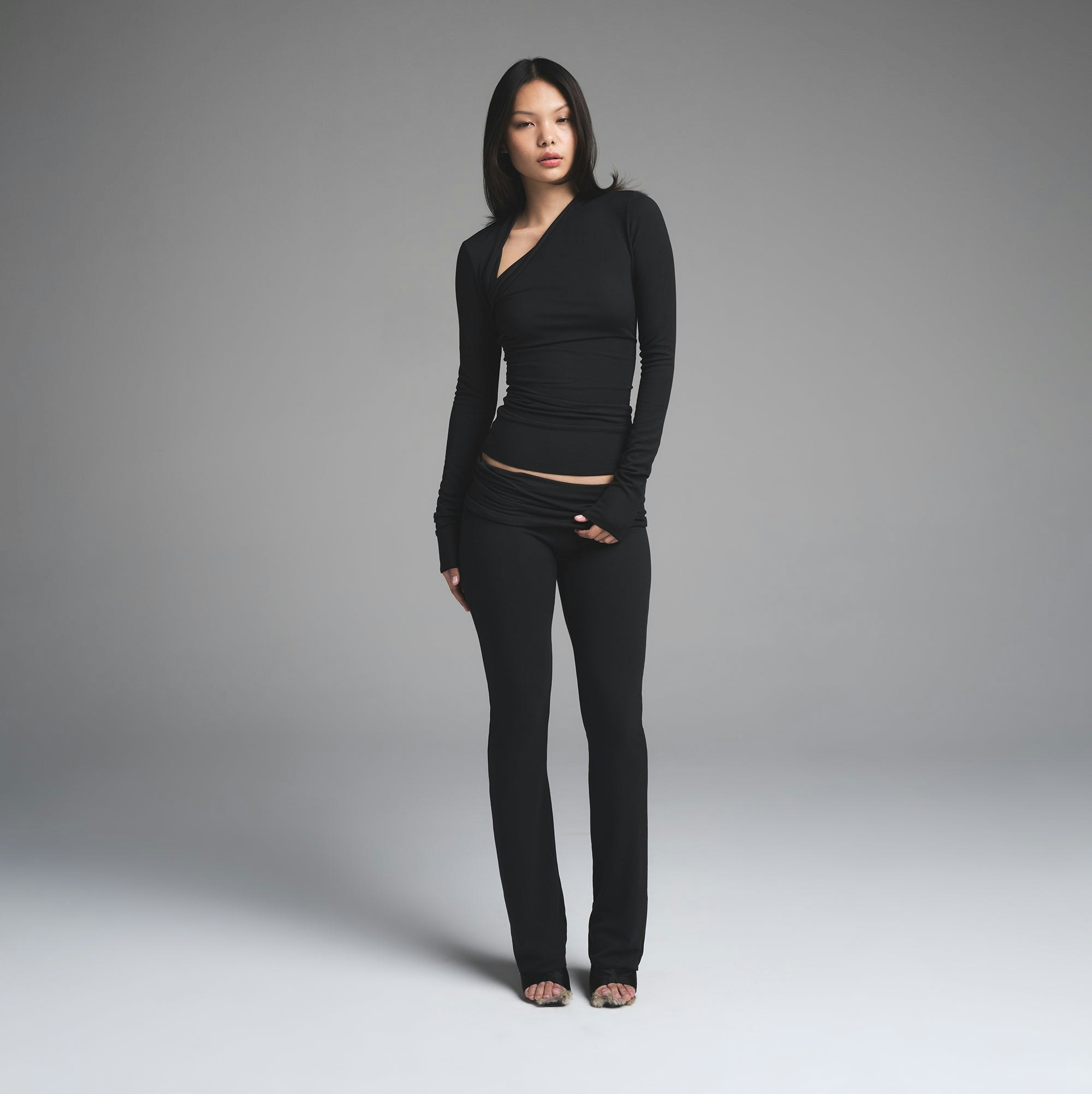 SKIMS CLOUD ASYMMETRIC LONG SLEEVE TOP | ONYX ON A MODEL FRONT VIEW | FOCUS: 0.0, 1.0, 0.9