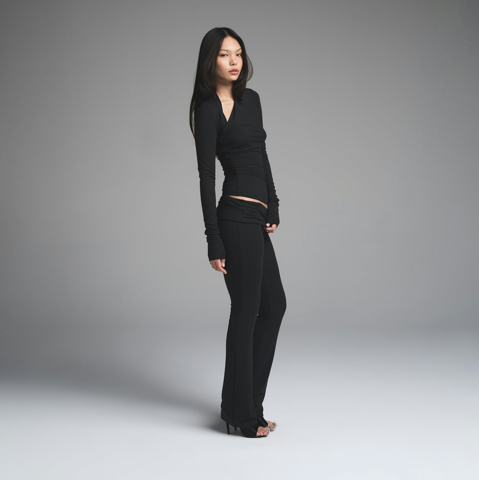 SKIMS CLOUD ASYMMETRIC LONG SLEEVE TOP | ONYX ON A MODEL SIDE VIEW | FOCUS: 0.0, 1.0, 0.9