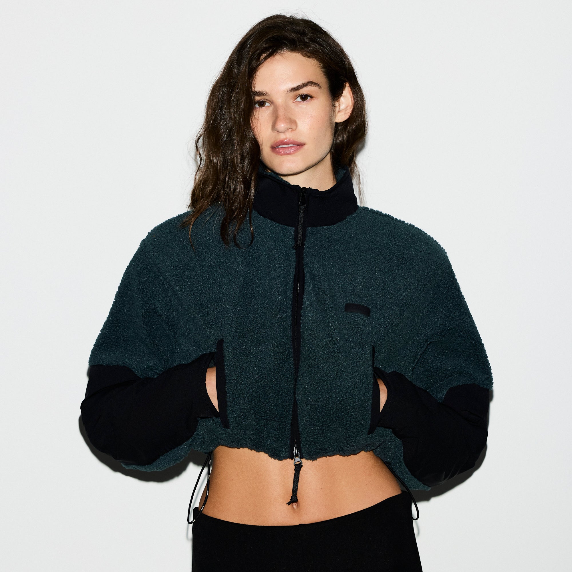 TEDDY FUNNEL NECK CROPPED JACKET | DARK TEAL ON A MODEL SIDE VIEW @ | FOCUS: 0.0, 1.0, 0.9