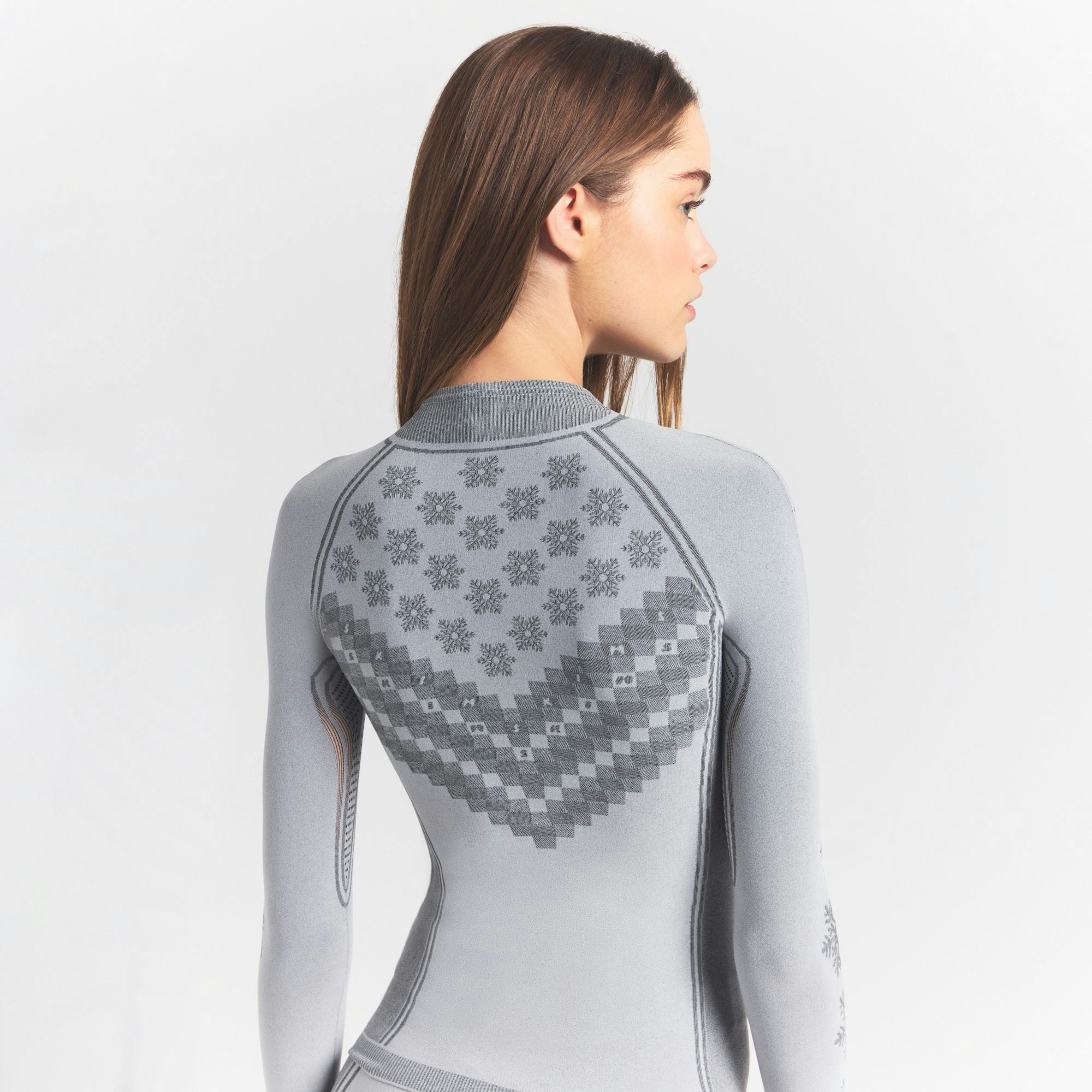SKIMS FIRST LAYERS HALF ZIP LONG SLEEVE | MIRROR WINTER FAIR ISLE ON A MODEL SIDE VIEW @ | FOCUS: 0.0, 1.0, 0.9