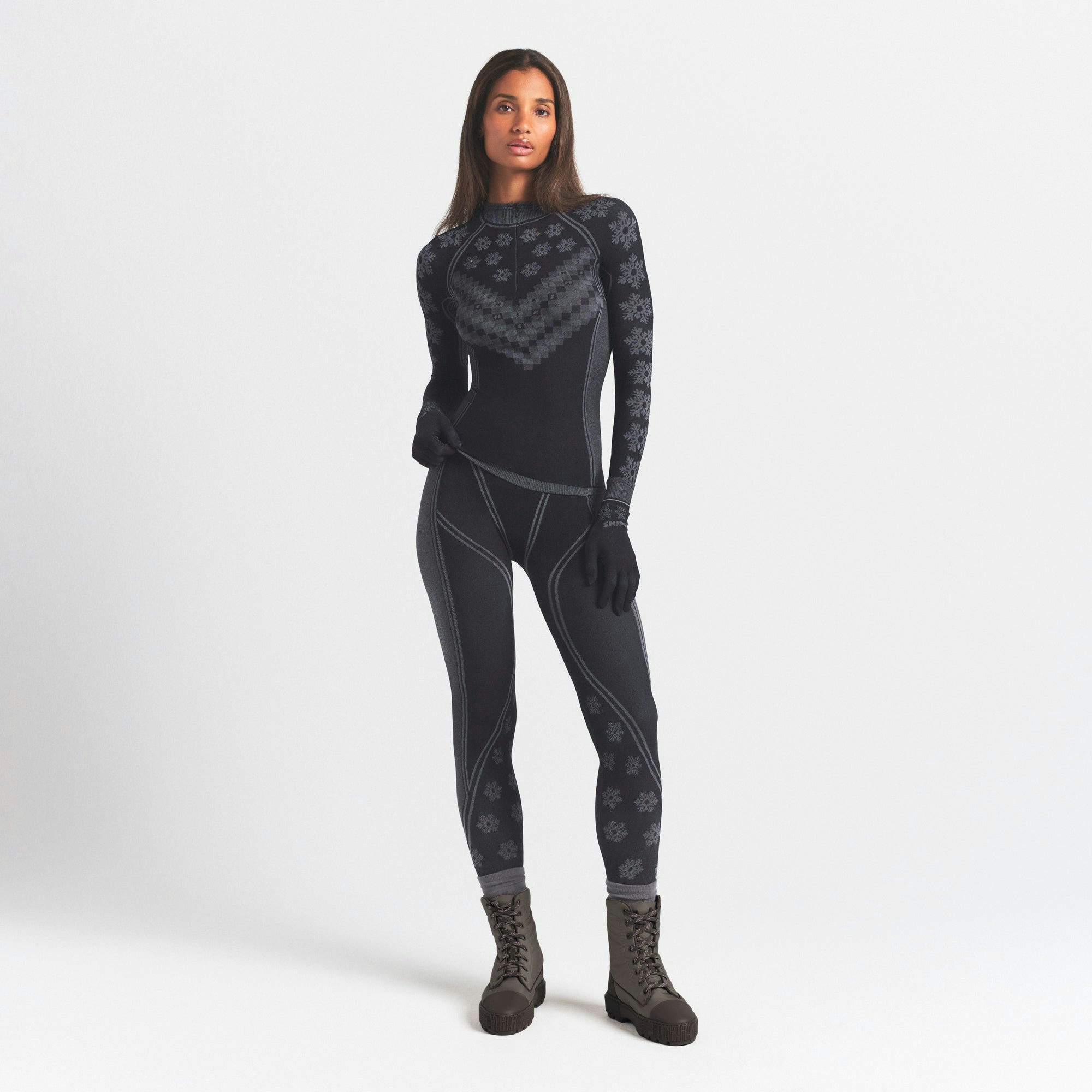 SKIMS FIRST LAYERS HALF ZIP LONG SLEEVE | OBSIDIAN WINTER FAIR ISLE ON A MODEL FRONT VIEW @ | FOCUS: 0.0, 1.0, 0.9