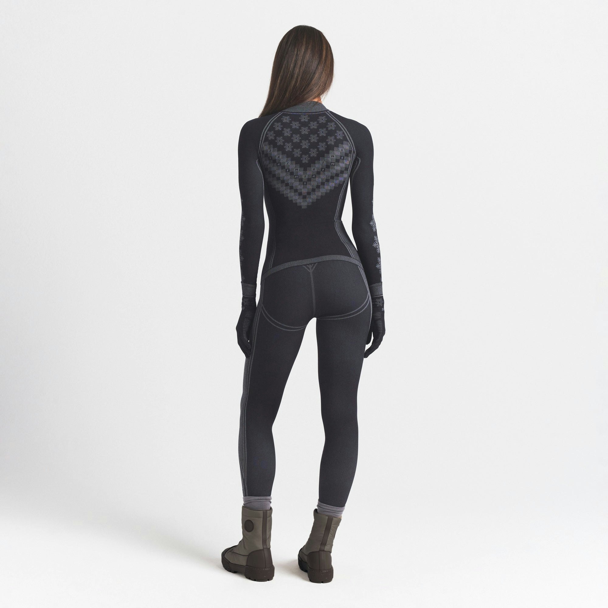 SKIMS FIRST LAYERS HALF ZIP LONG SLEEVE | OBSIDIAN WINTER FAIR ISLE ON A MODEL SIDE VIEW @ | FOCUS: 0.0, 1.0, 0.9