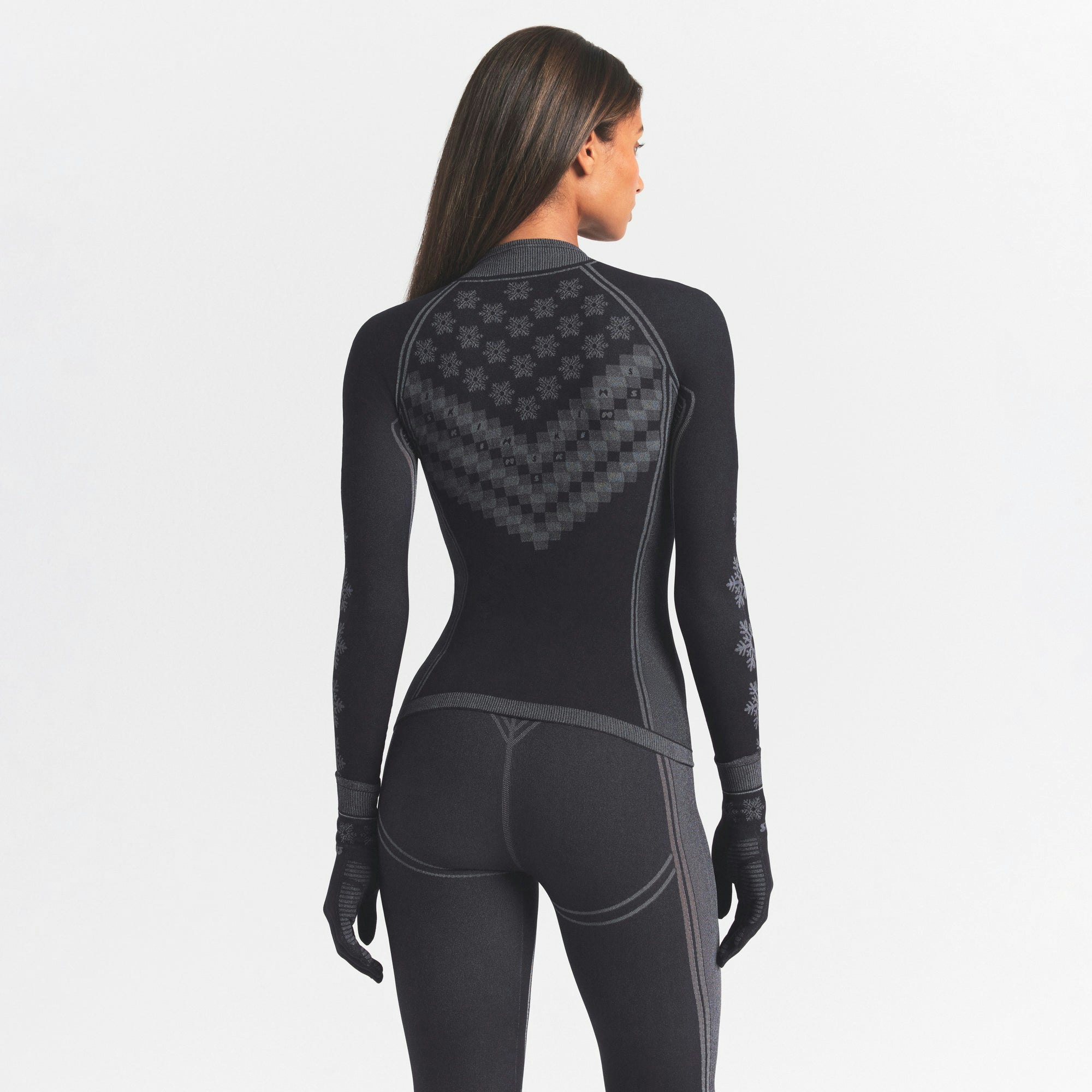 SKIMS FIRST LAYERS HALF ZIP LONG SLEEVE | OBSIDIAN WINTER FAIR ISLE ON A MODEL SIDE VIEW @ | FOCUS: 0.0, 1.0, 0.9