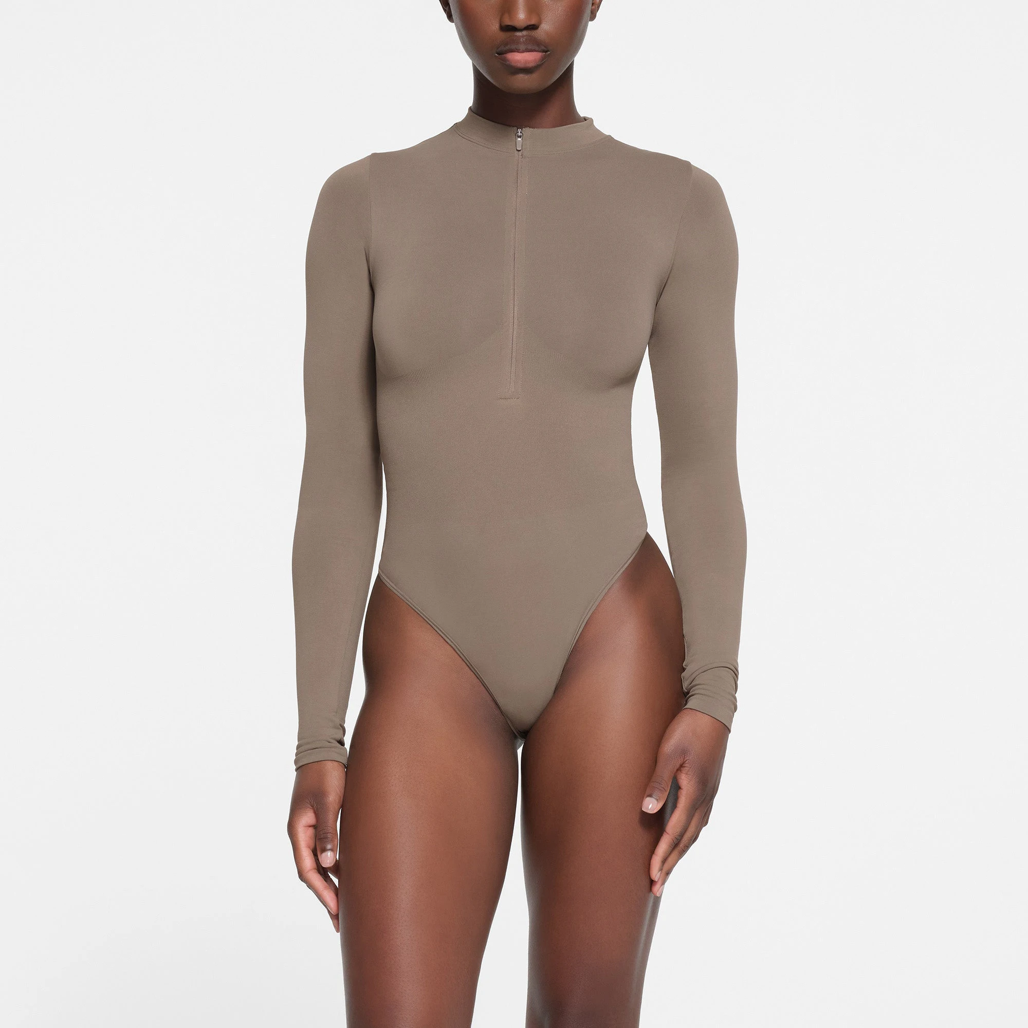 CONTOUR NYLON ZIP FRONT LONG SLEEVE BODYSUIT | TRUFFLE ON A MODEL FRONT VIEW