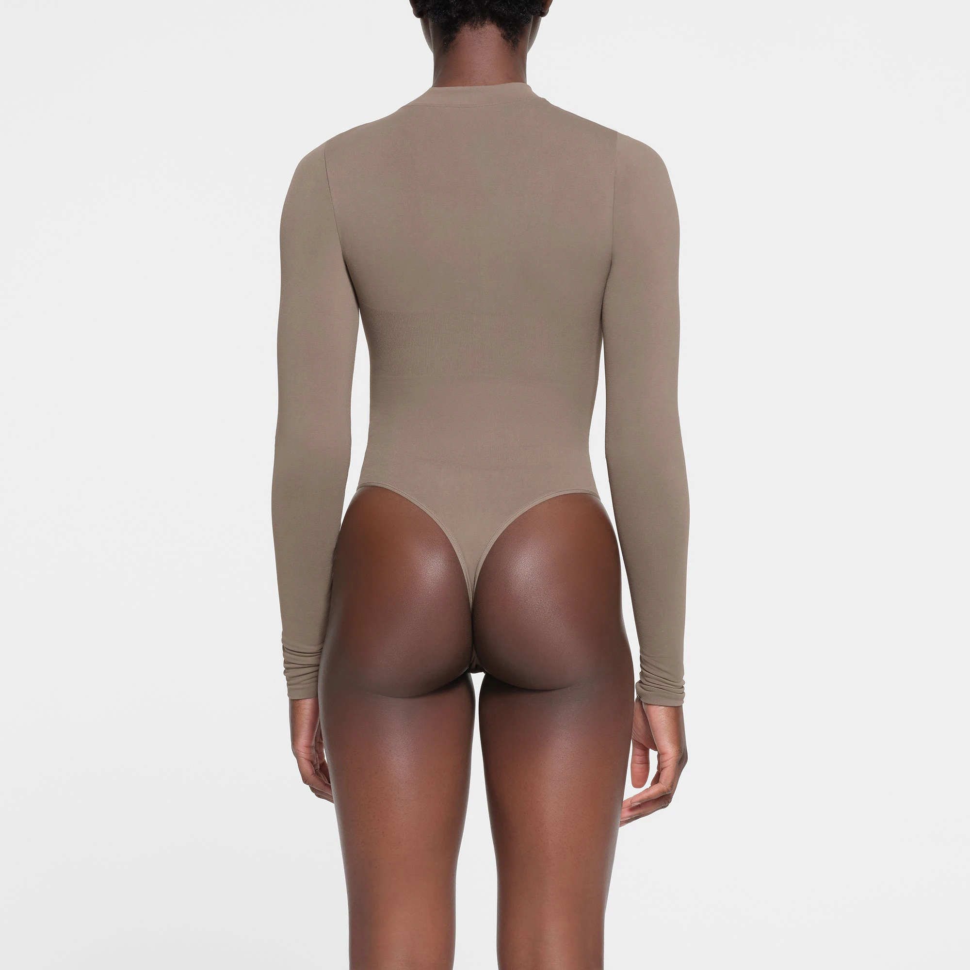 CONTOUR NYLON ZIP FRONT LONG SLEEVE BODYSUIT | TRUFFLE ON A MODEL BACK VIEW