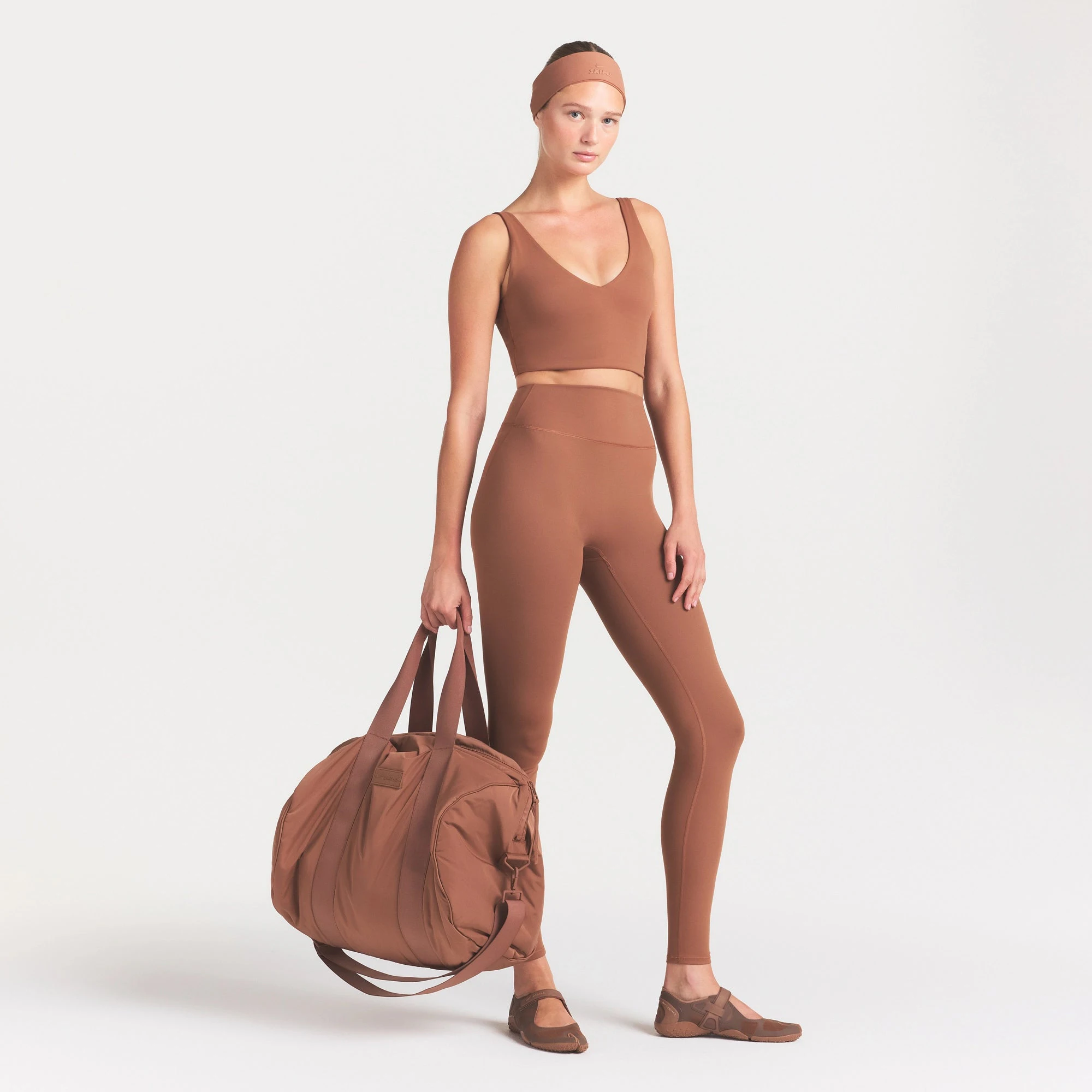 NikeSKIMS MATTE 29" LEGGING | CAROB BROWN ON A MODEL FRONT VIEW