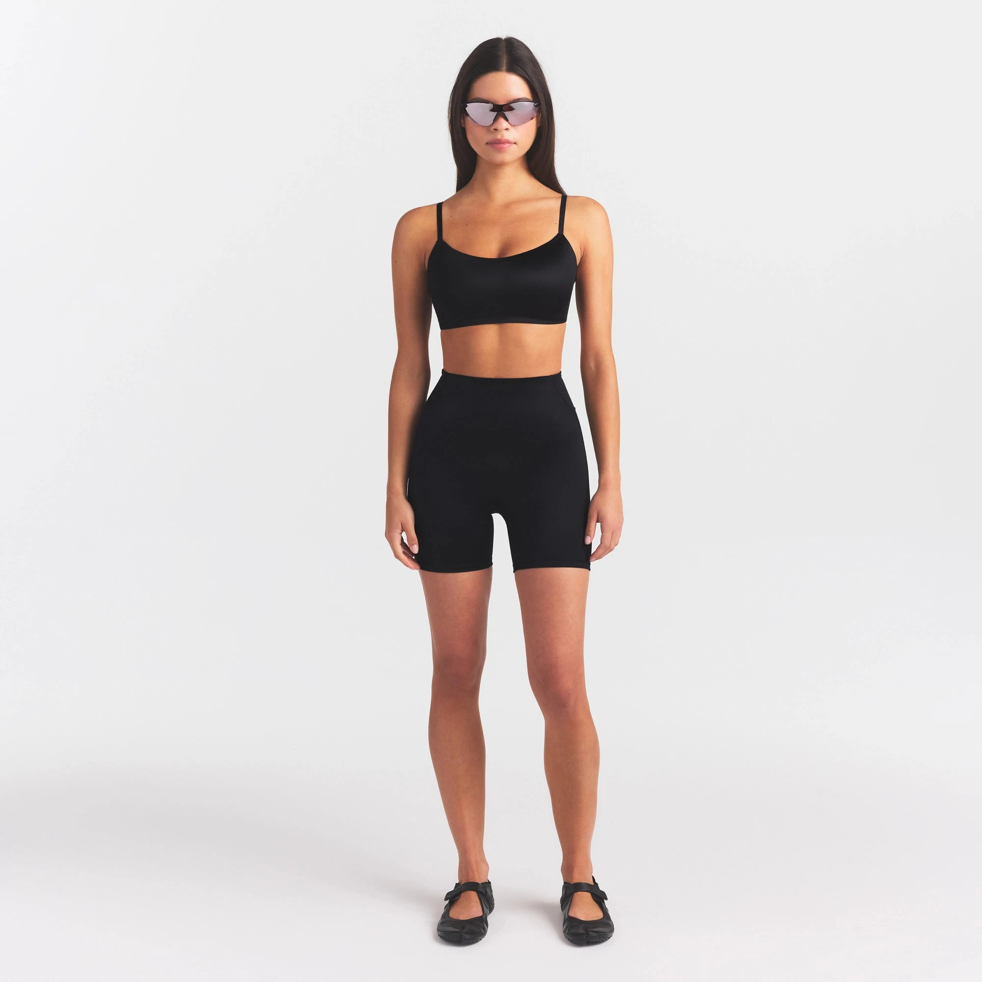 NikeSKIMS SATIN SHINE BONDED WAIST 5" BIKER SHORT | OBSIDIAN ON A MODEL FRONT VIEW