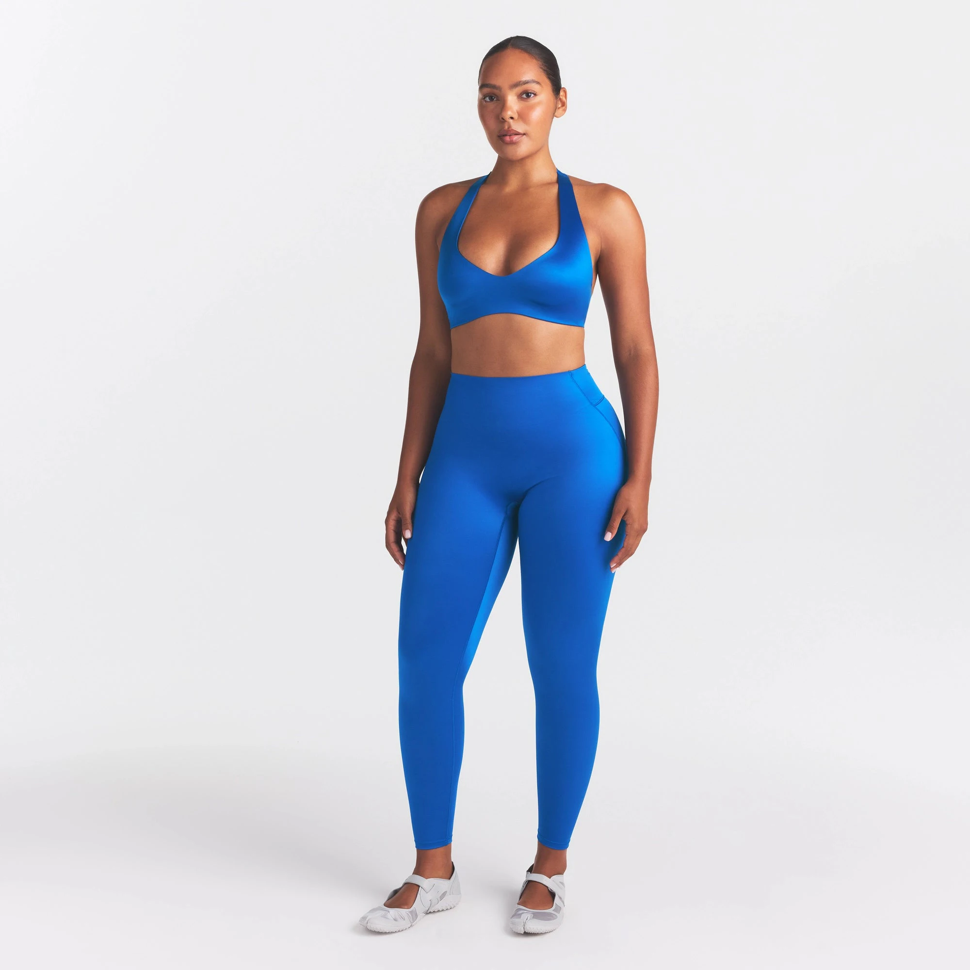 NikeSKIMS SATIN SHINE BONDED WAIST LEGGING 26" | COBALT ON A MODEL FRONT VIEW