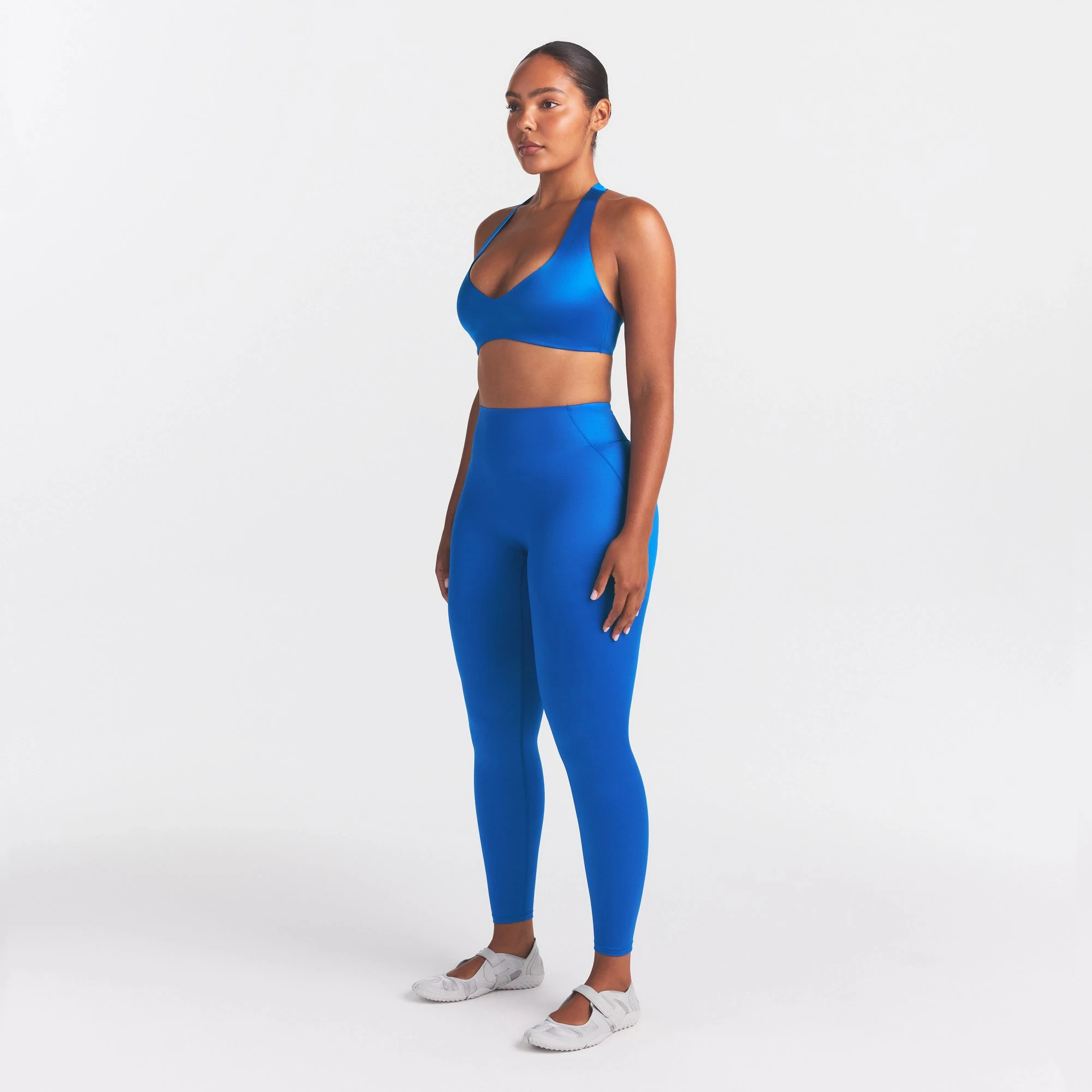 NikeSKIMS SATIN SHINE BONDED WAIST LEGGING 26" | COBALT ON A MODEL FRONT VIEW