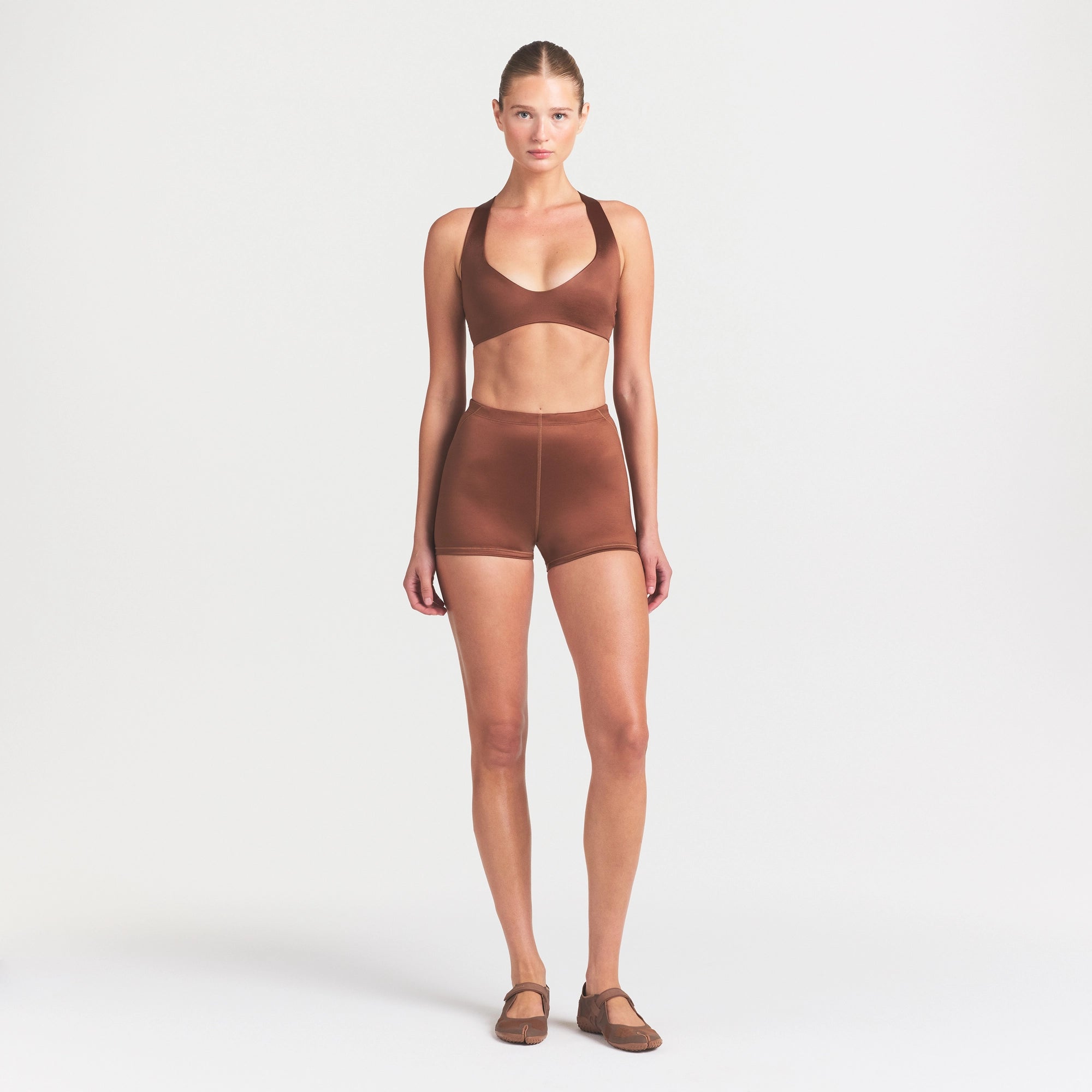NikeSKIMS SATIN SHINE DRAWCORD 2" SHORT | CAROB BROWN ON A MODEL FRONT VIEW