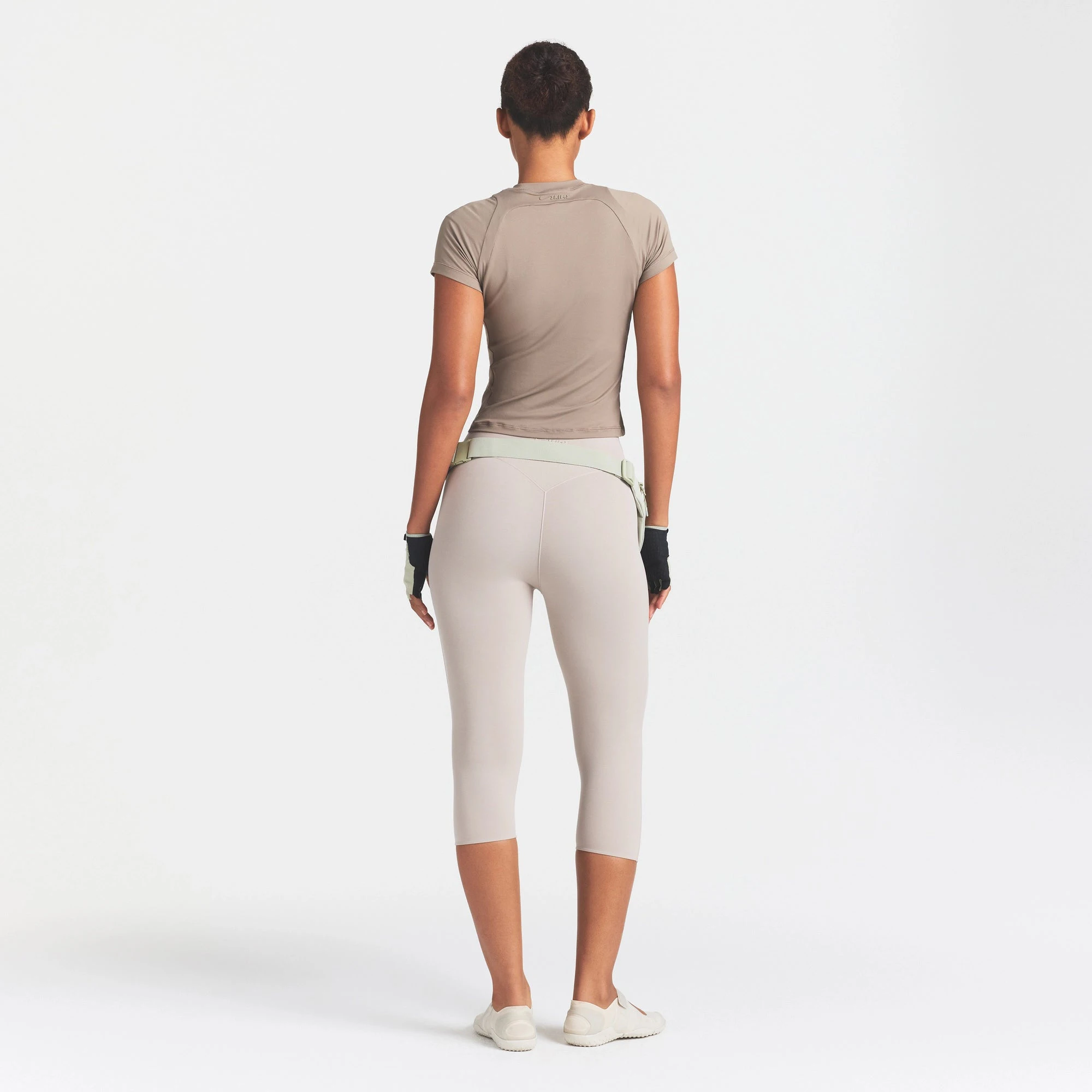 NikeSKIMS STUDIO STRETCH 17" CAPRI LEGGING | LINEN ON A MODEL FRONT VIEW
