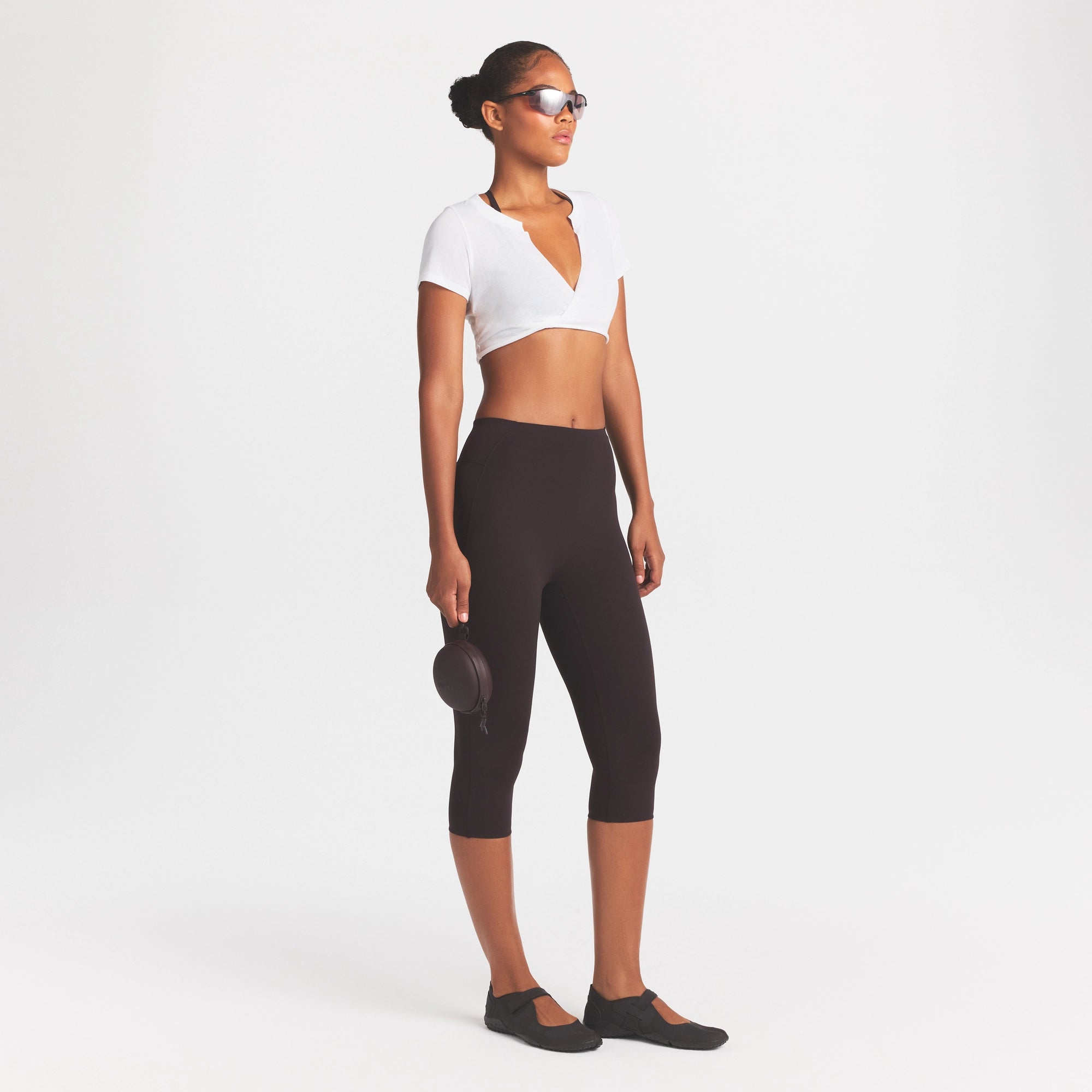 NikeSKIMS STUDIO STRETCH 17" CAPRI LEGGING | DARK ROAST/(NSKMDR) ON A MODEL FRONT VIEW | FOCUS: 0.0, 1.0, 0.9