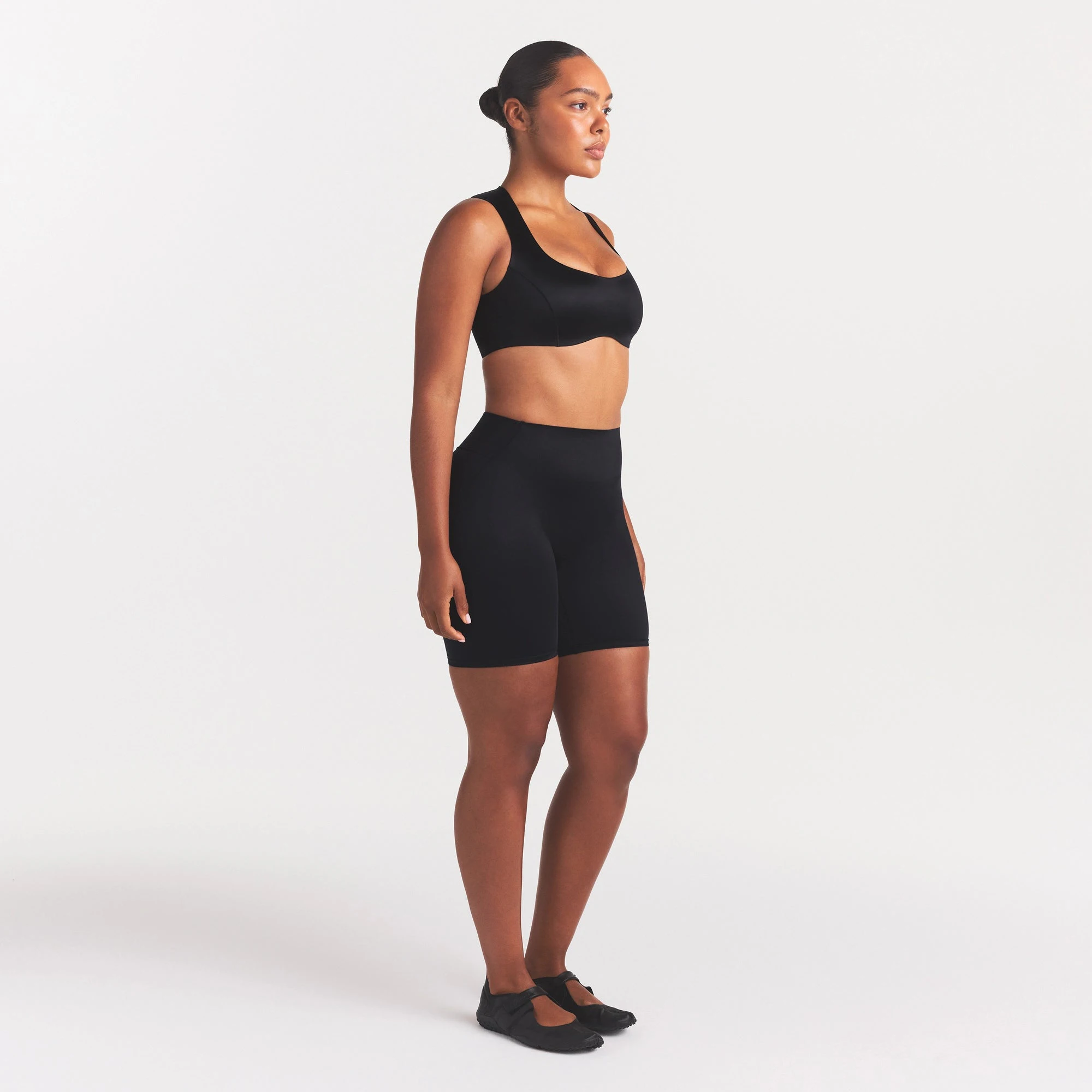 NikeSKIMS SATIN SHINE BONDED WAIST 7" BIKER SHORT | OBSIDIAN ON A MODEL FRONT VIEW
