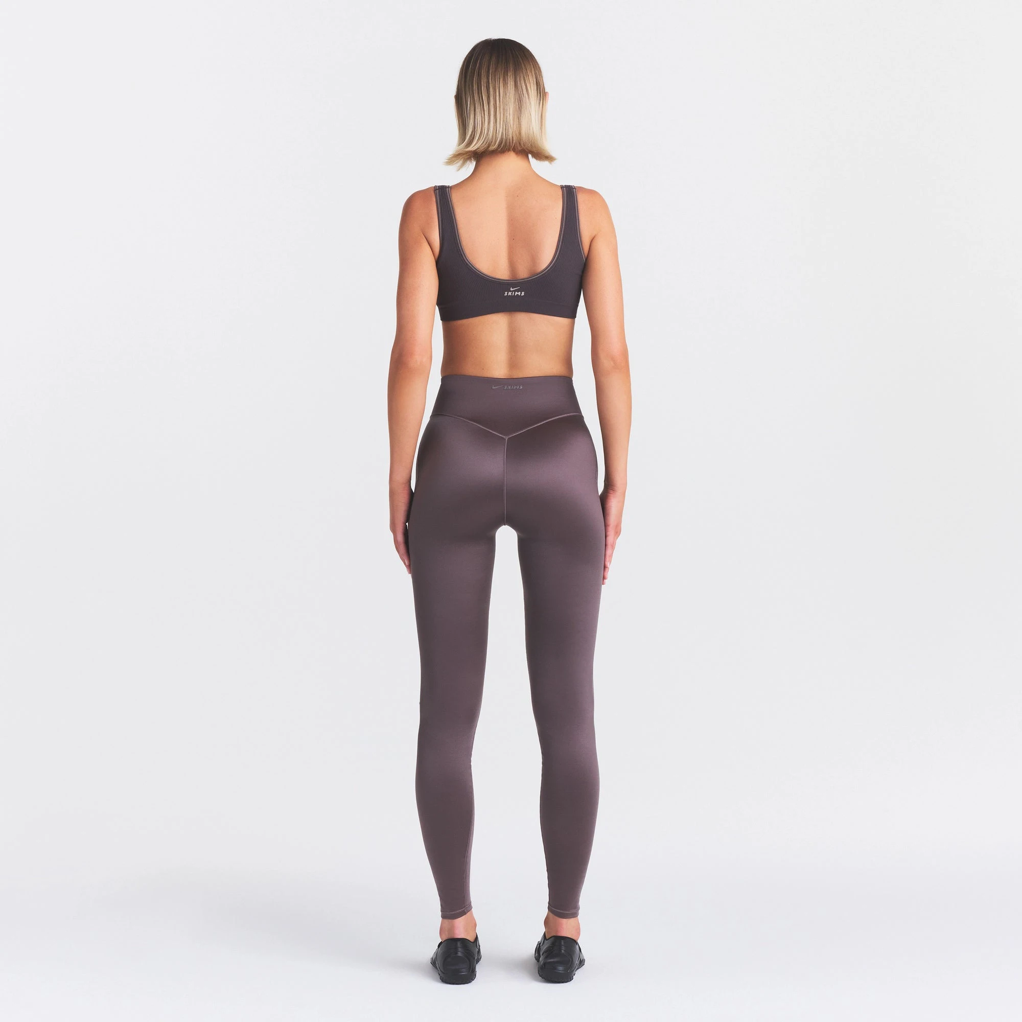 NikeSKIMS SATIN SHINE BONDED WAIST 29" LEGGING | RESIN ON A MODEL FRONT VIEW