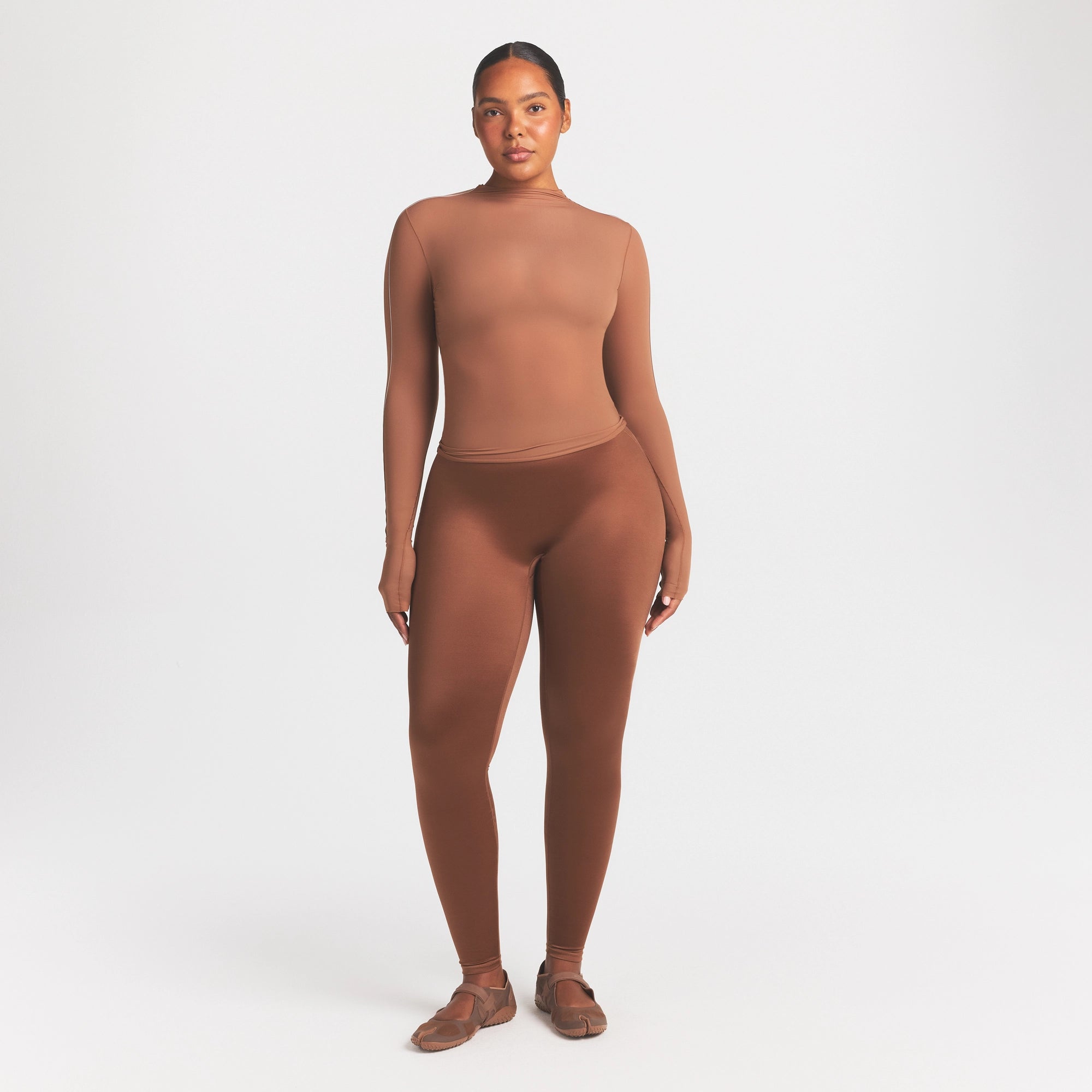 NikeSKIMS SATIN SHINE BONDED WAIST 29" LEGGING | CAROB BROWN ON A MODEL FRONT VIEW
