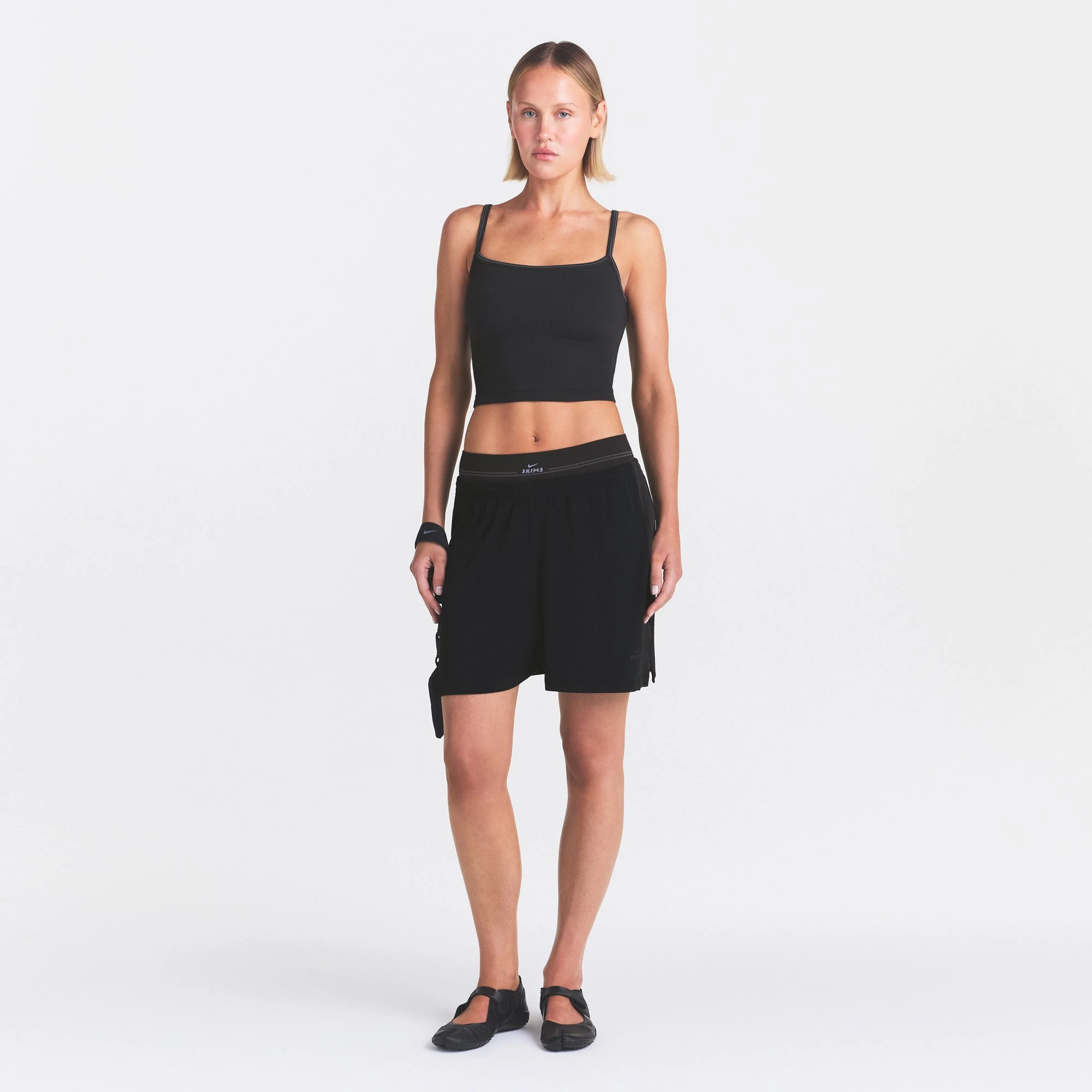 NikeSKIMS STRETCH KNIT DOLPHIN SHORT | OBSIDIAN ON A MODEL FRONT VIEW @ | FOCUS: 0.0, 1.0, 0.9