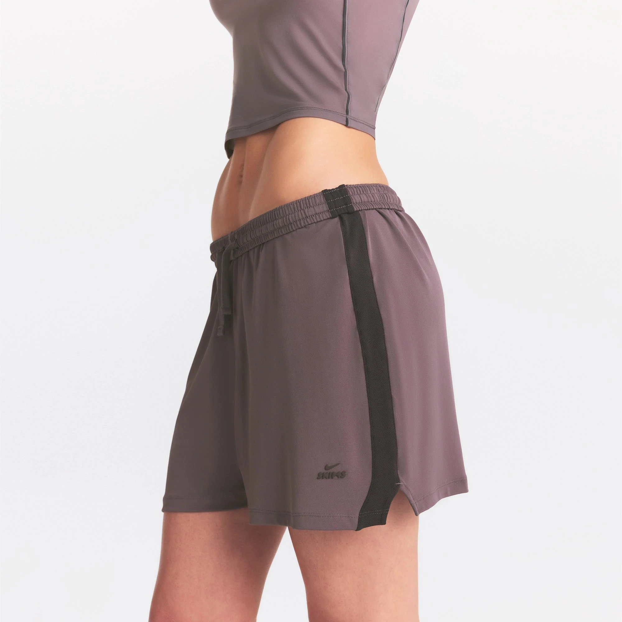NikeSKIMS STRETCH KNIT DOLPHIN SHORT | RESIN ON A MODEL SIDE VIEW @ | FOCUS: 0.0, 1.0, 0.9