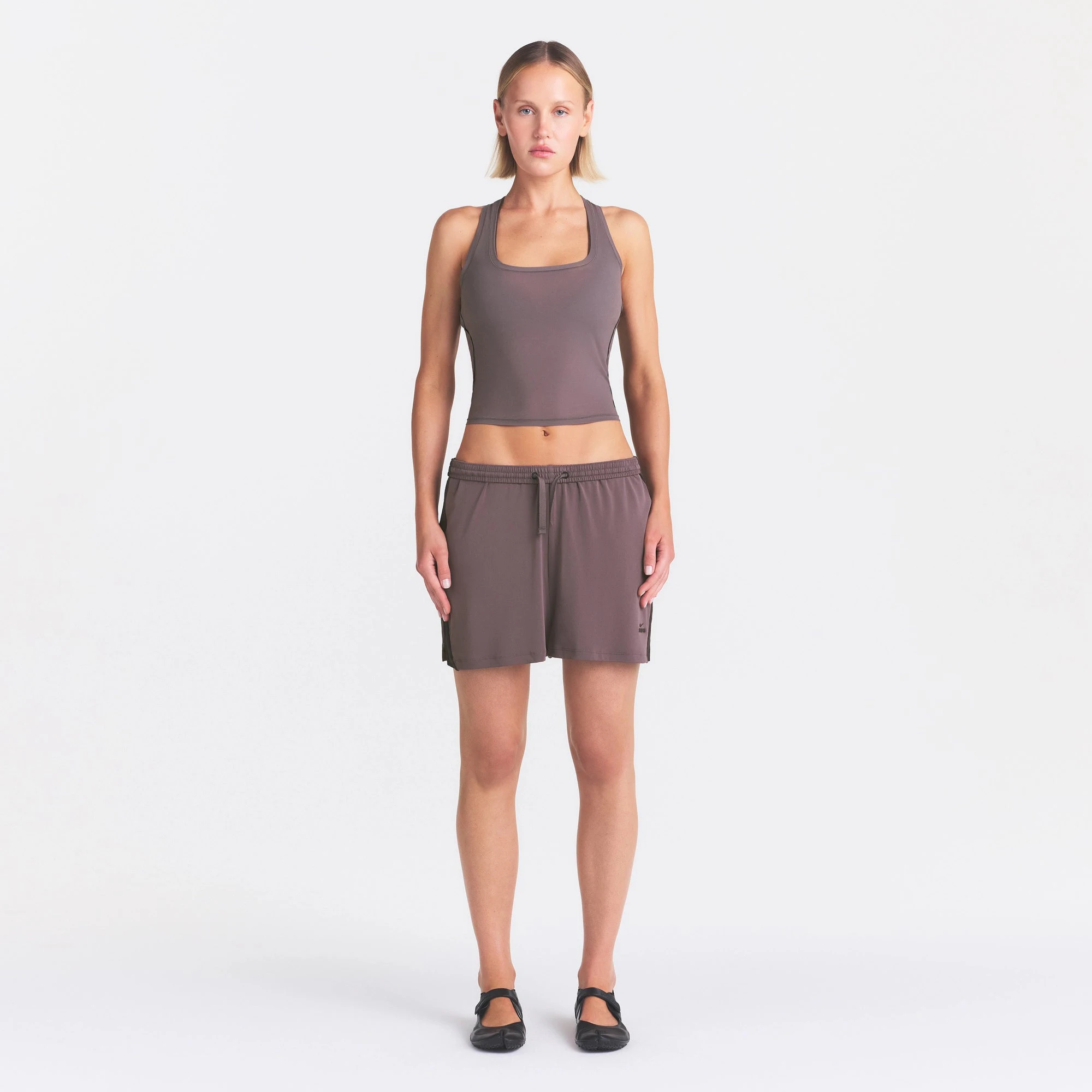 NikeSKIMS STRETCH KNIT DOLPHIN SHORT | RESIN ON A MODEL FRONT VIEW @ | FOCUS: 0.0, 1.0, 0.9