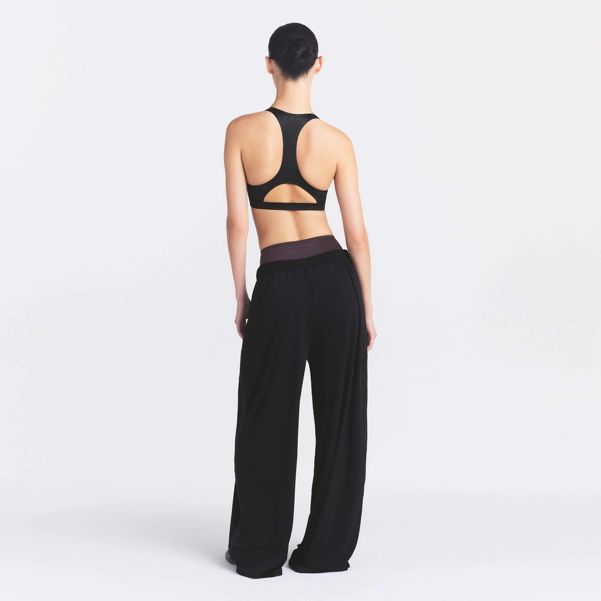 NikeSKIMS STRETCH KNIT WIDE LEG PANT | OBSIDIAN ON A MODEL FRONT VIEW @ | FOCUS: 0.0, 1.0, 0.9