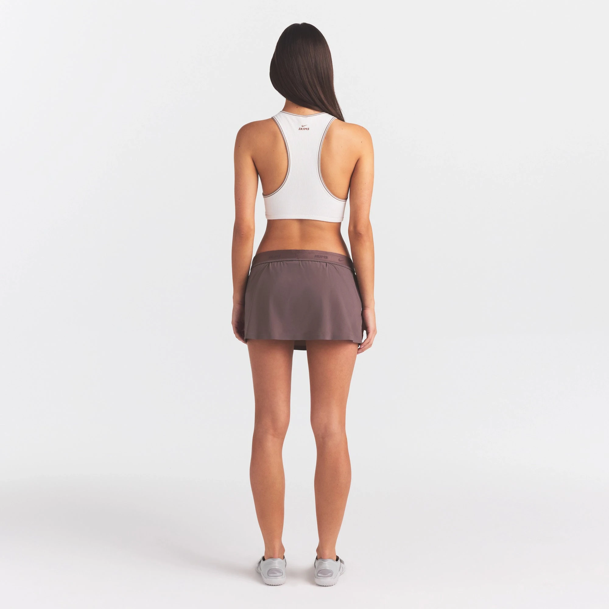 NikeSKIMS STRETCH NYLON SKORT | RESIN ON A MODEL FRONT VIEW @ | FOCUS: 0.0, 1.0, 0.9