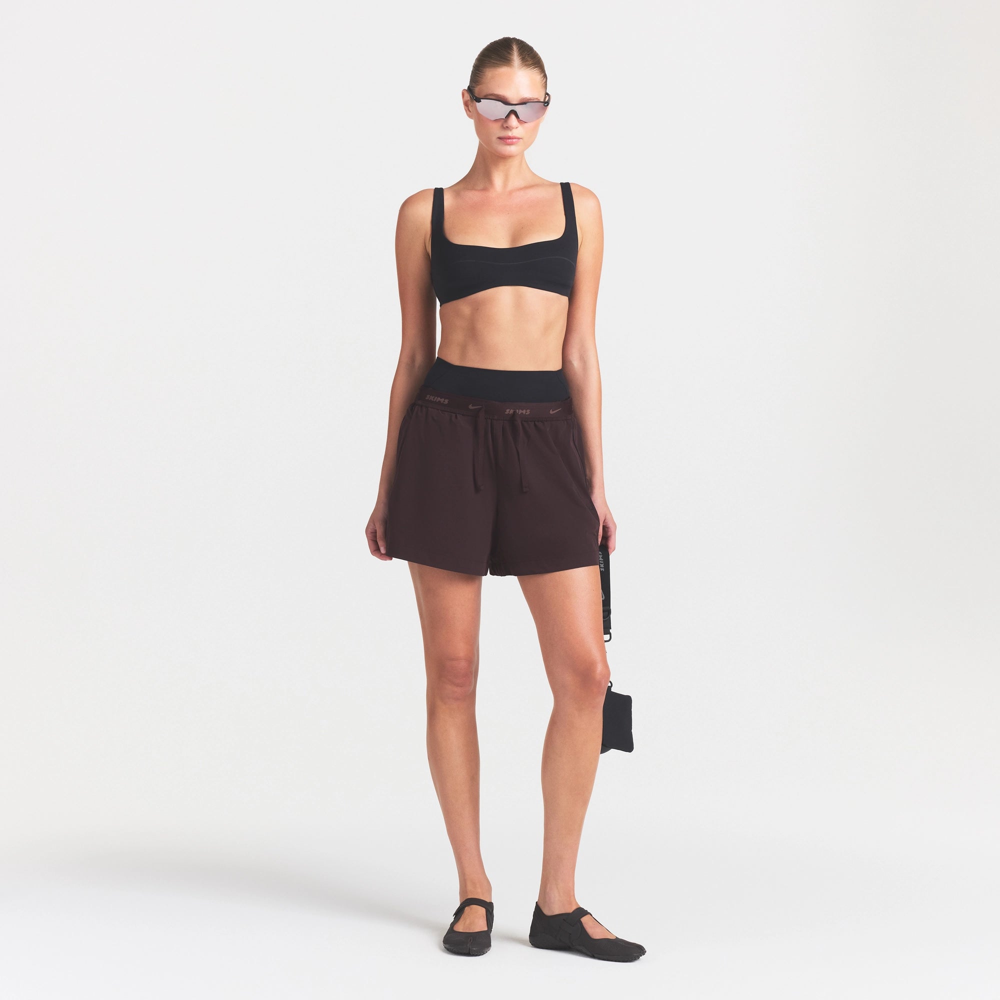 NikeSKIMS STRETCH NYLON 5" TRACK SHORT | DARK ROAST ON A MODEL FRONT VIEW
