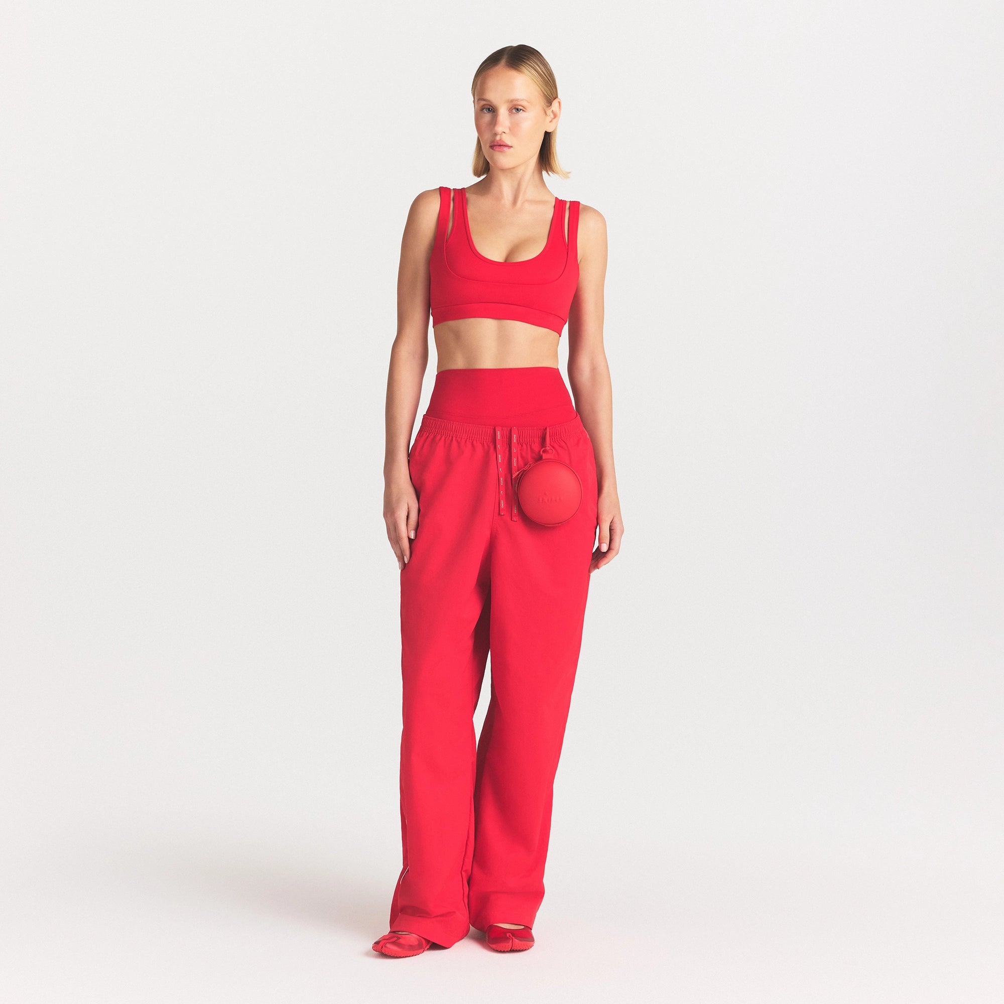 NikeSKIMS CRUNCHY NYLON WIDE LEG PANT | UNIVERSITY RED ON A MODEL FRONT VIEW @ | FOCUS: 0.0, 1.0, 0.9