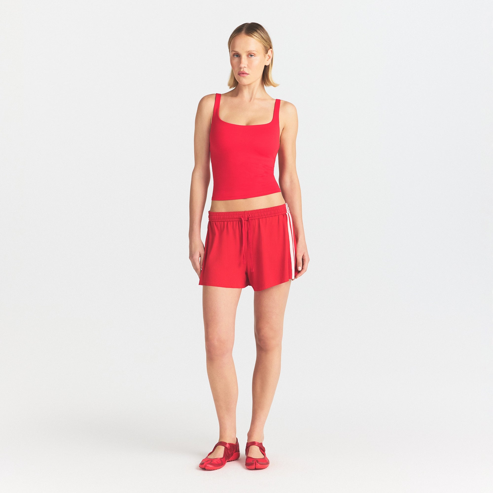 NikeSKIMS STRETCH KNIT SHORT | SPORT RED/ECRU ON A MODEL FRONT VIEW @ | FOCUS: 0.0, 1.0, 0.9