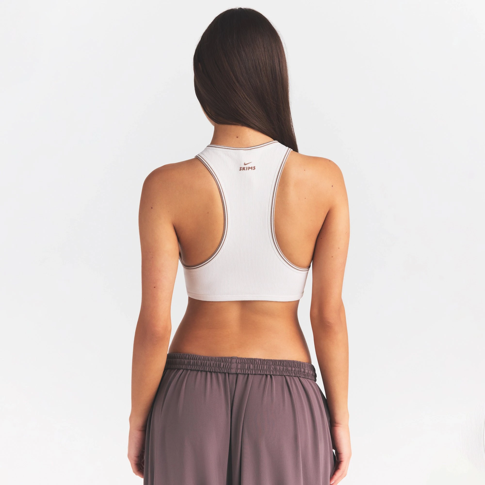 NikeSKIMS RIBBED SEAMLESS RACER FRONT BRA | IVORY ON A MODEL SIDE VIEW @ | FOCUS: 0.0, 1.0, 0.9