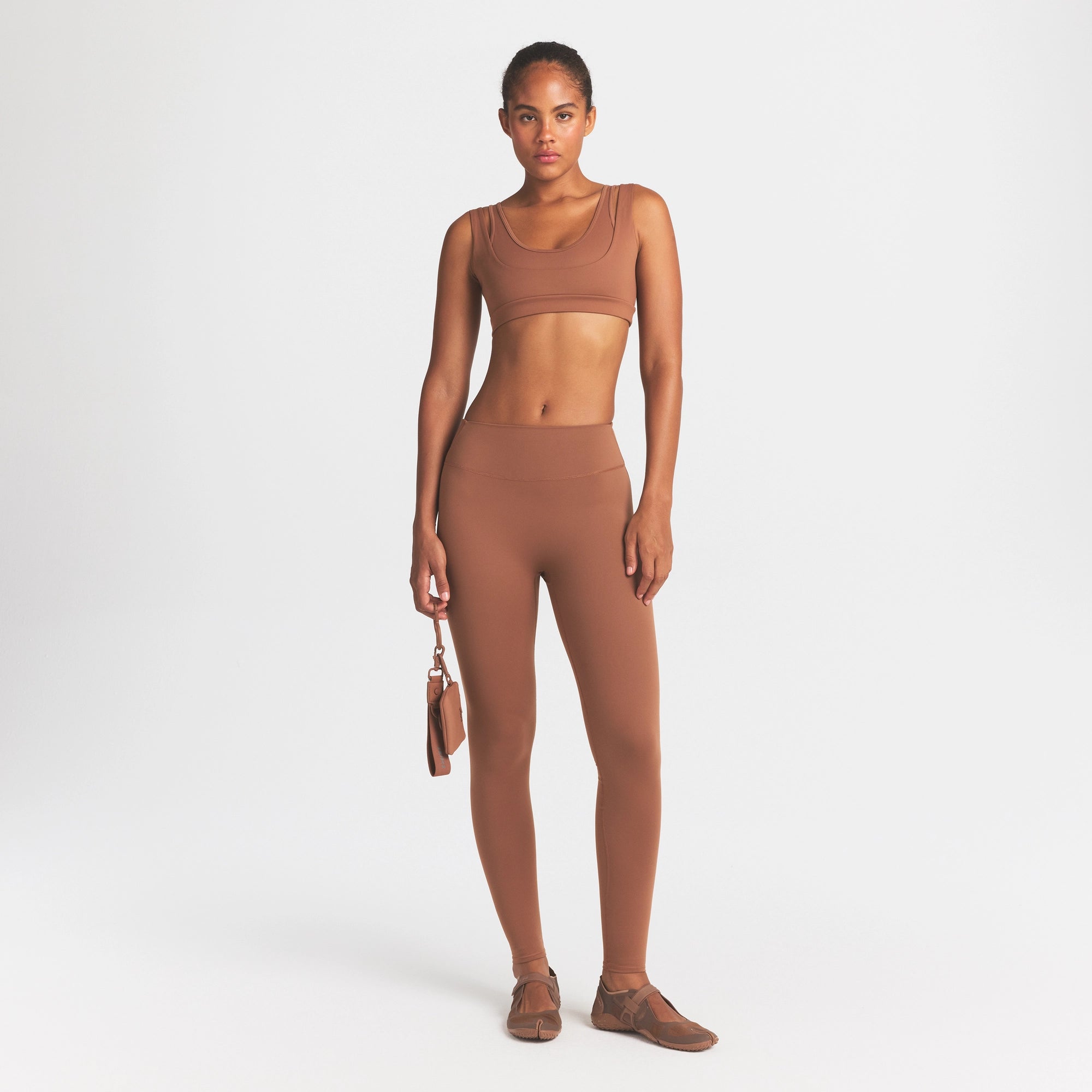 NikeSKIMS MATTE DOUBLE STRAP SCOOP BRA | CAROB BROWN ON A MODEL FRONT VIEW @ | FOCUS: 0.0, 1.0, 0.9