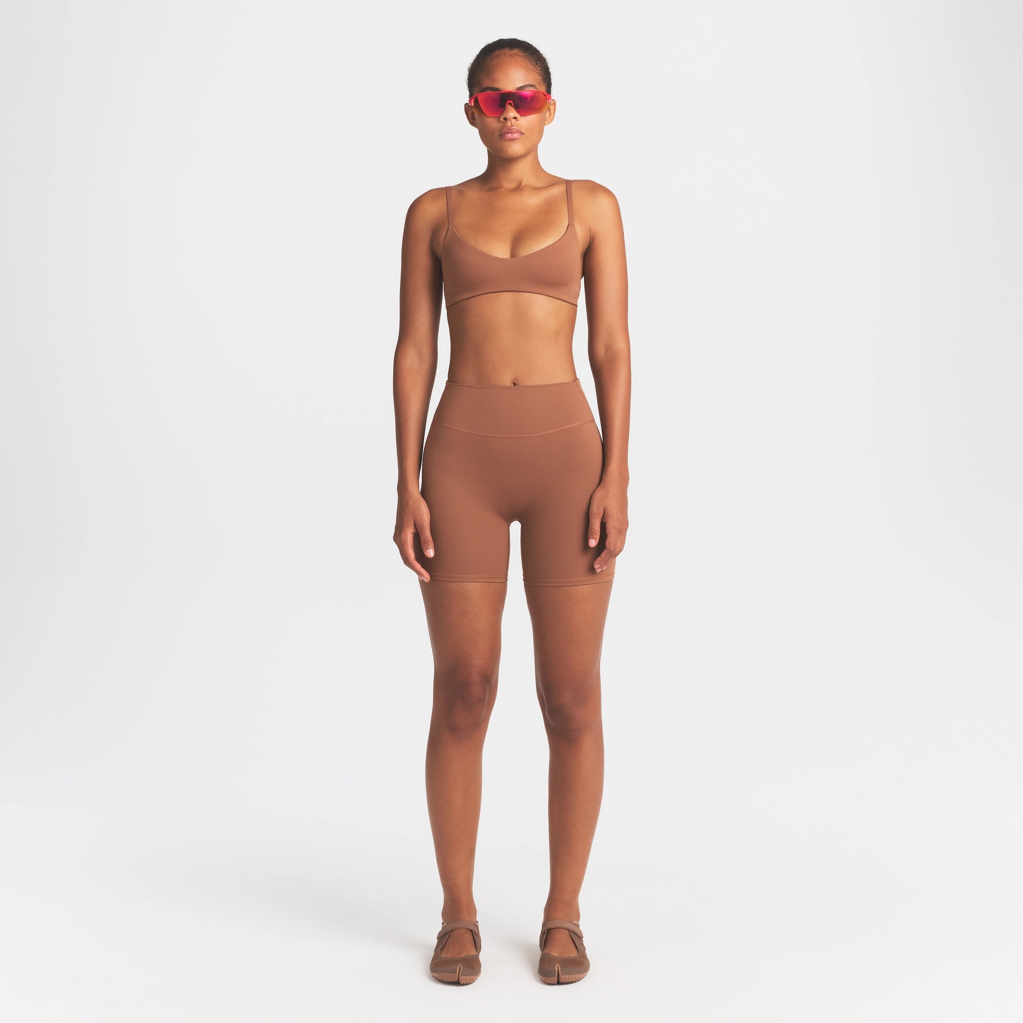 NikeSKIMS MATTE MICRO SCOOP BRA | CAROB BROWN ON A MODEL FRONT VIEW @ | FOCUS: 0.0, 1.0, 0.9