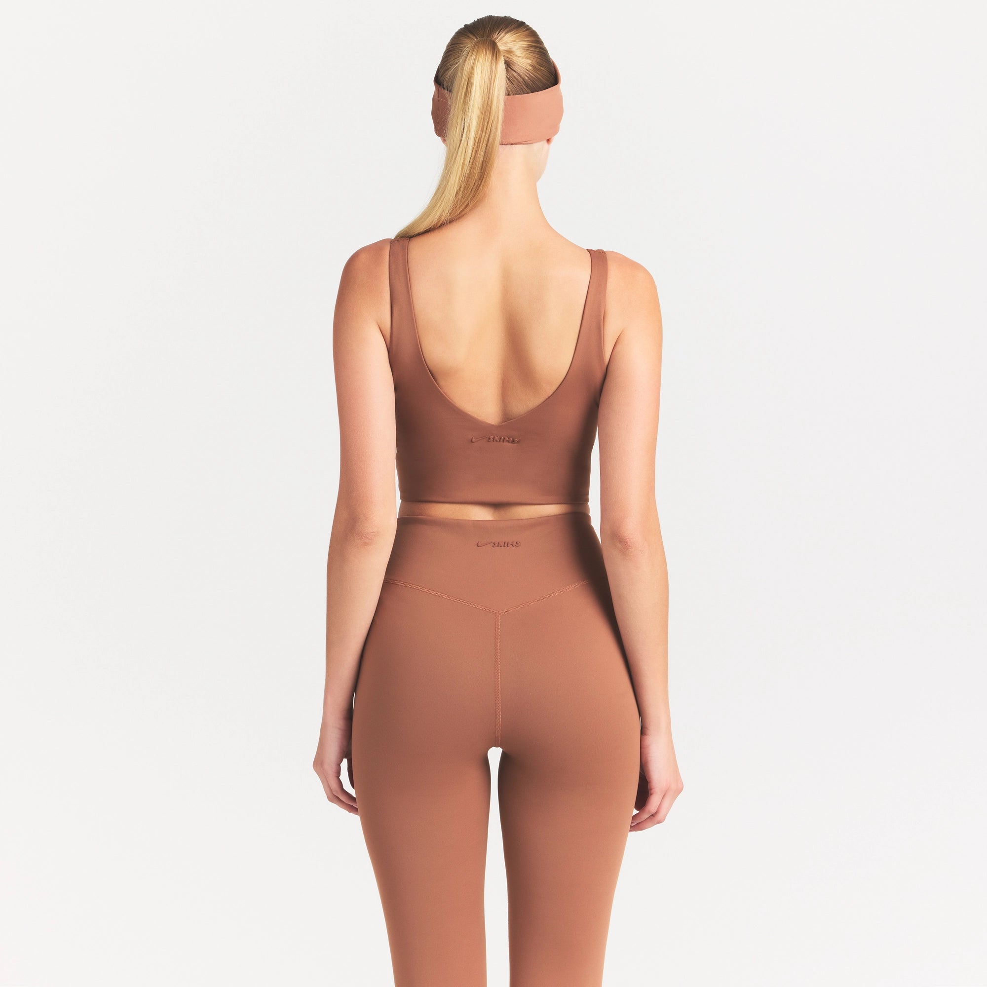 NikeSKIMS MATTE V-NECK BRA TOP | CAROB BROWN ON A MODEL SIDE VIEW @ | FOCUS: 0.0, 1.0, 0.9