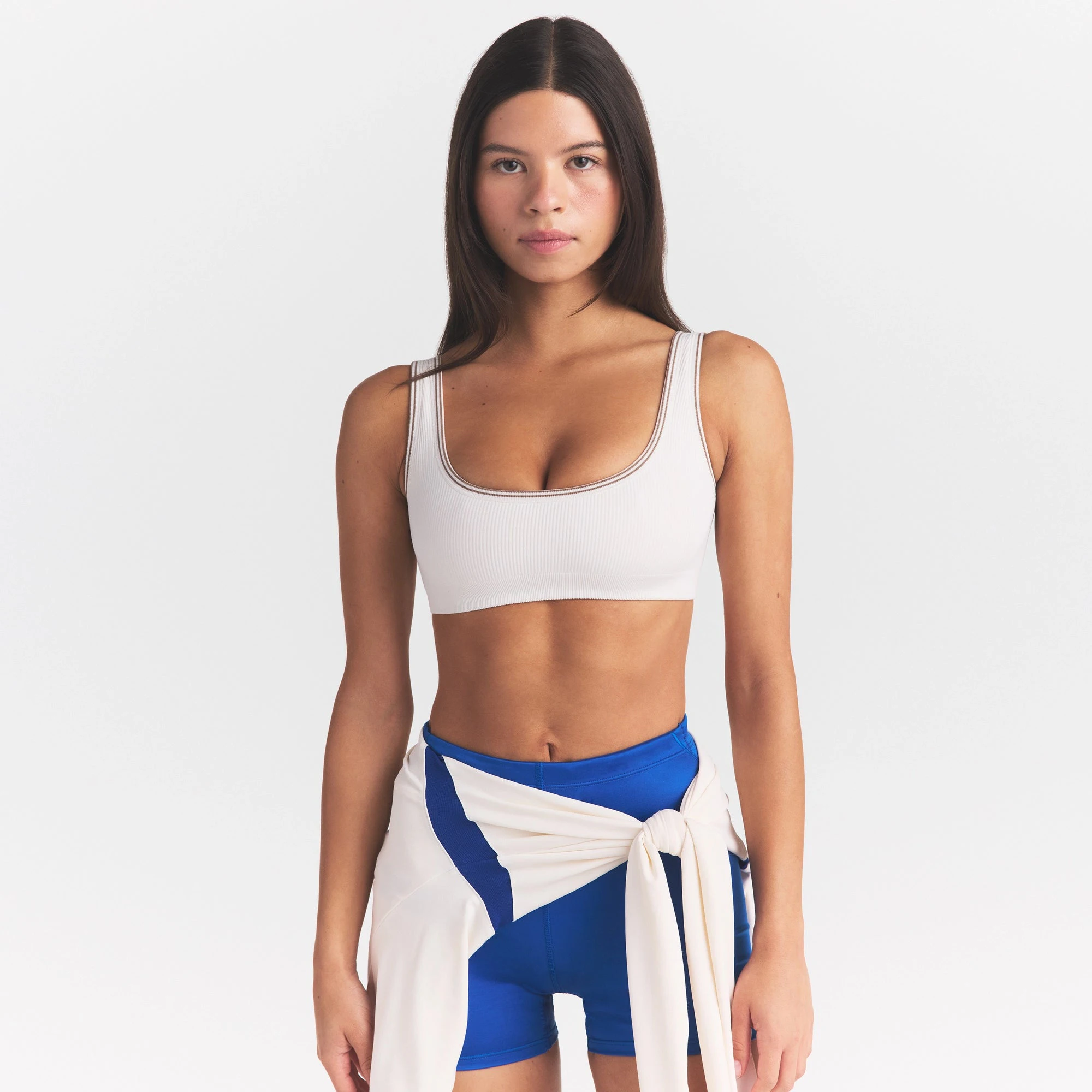 NikeSKIMS RIBBED SEAMLESS MICRO SCOOP BRA | IVORY ON A MODEL SIDE VIEW @ | FOCUS: 0.0, 1.0, 0.9
