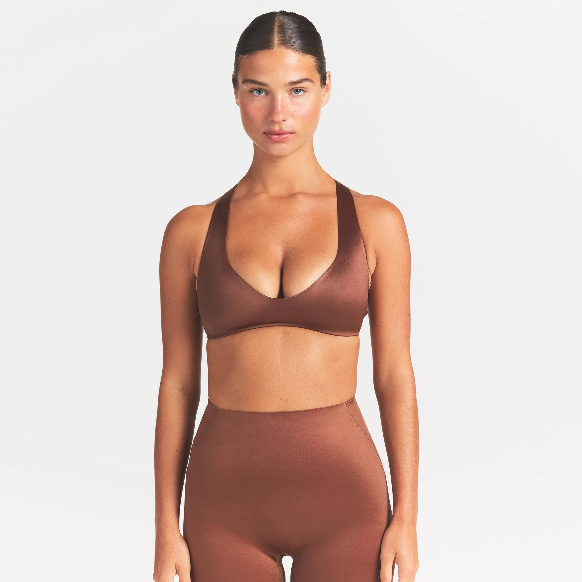 NikeSKIMS SATIN SHINE PLUNGE T-BACK BRA | CAROB BROWN ON A MODEL SIDE VIEW @ | FOCUS: 0.0, 1.0, 0.9