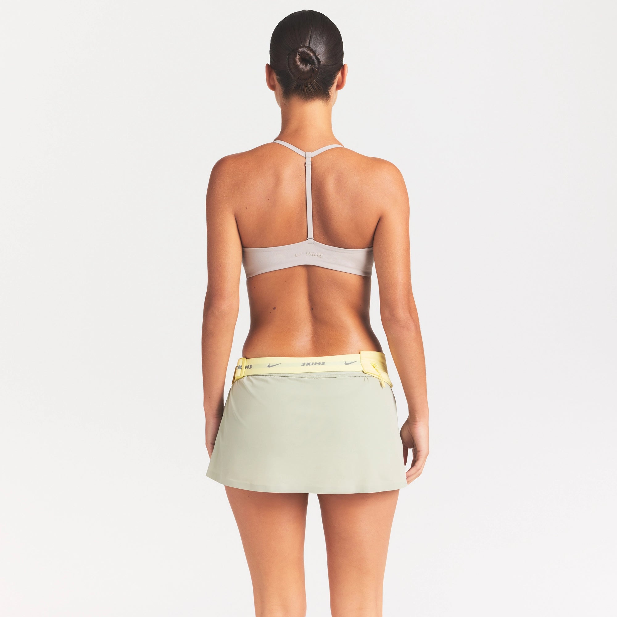NikeSKIMS STUDIO STRETCH T-BACK TRIANGLE BRA | LINEN ON A MODEL SIDE VIEW
