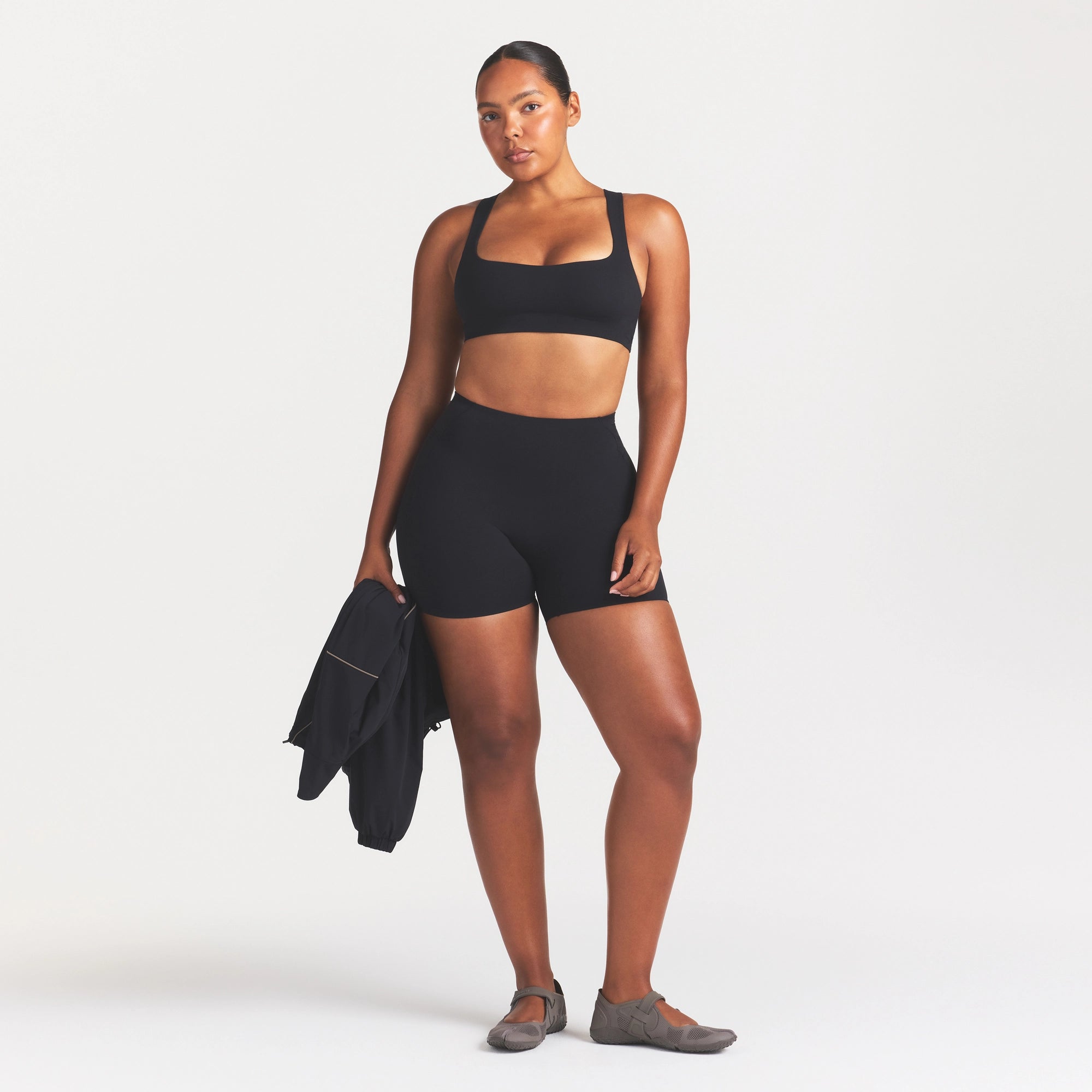 NikeSKIMS STUDIO STRETCH RACERBACK BRA | OBSIDIAN ON A MODEL FRONT VIEW @ | FOCUS: 0.0, 1.0, 0.9