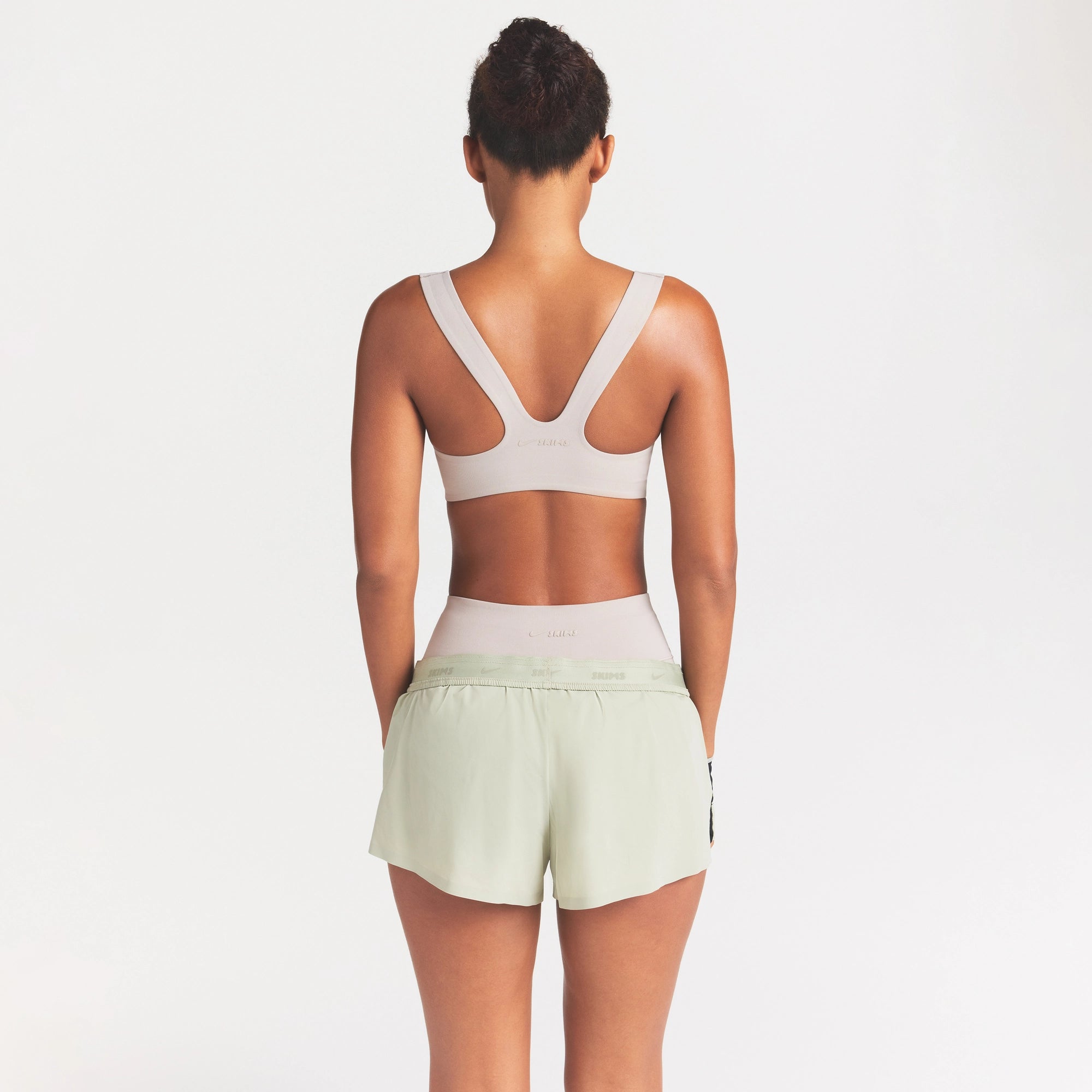 NikeSKIMS STUDIO STRETCH RACERBACK BRA | LINEN ON A MODEL SIDE VIEW