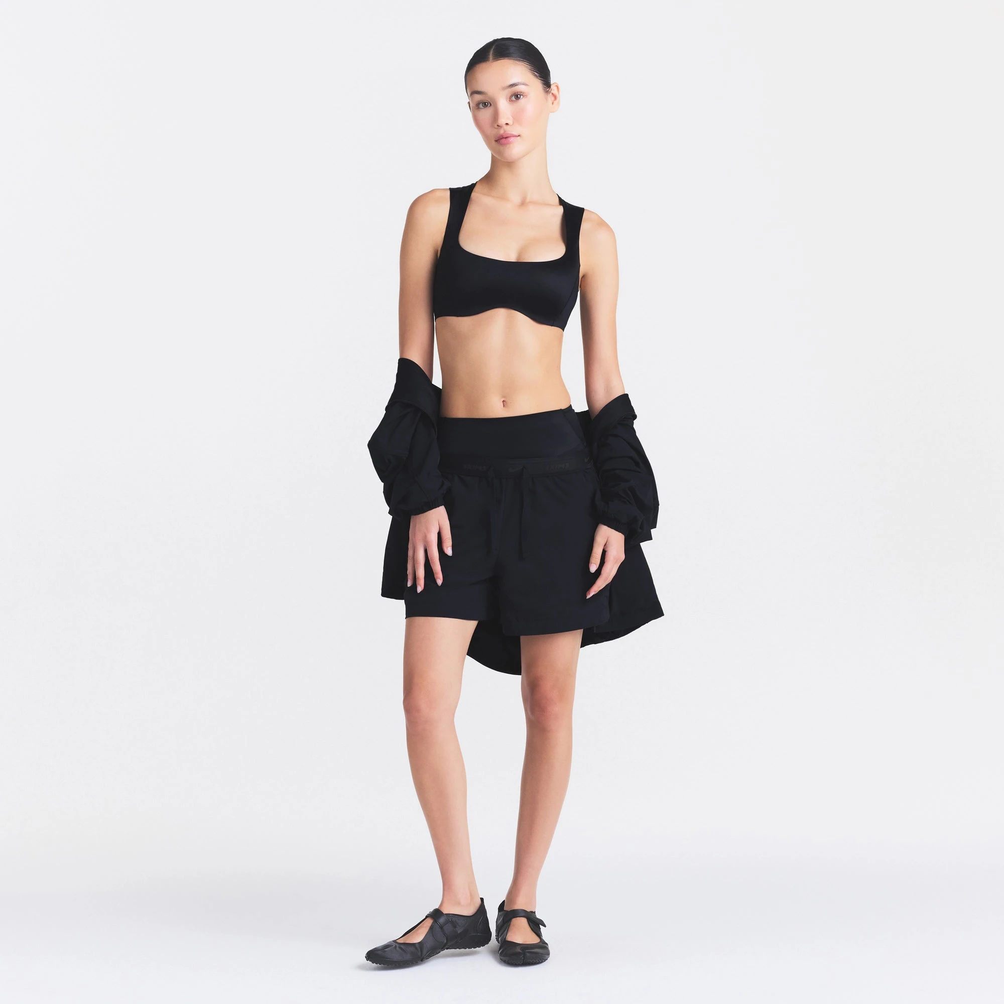 NikeSKIMS SATIN SHINE WIDE SCOOP BRA | OBSIDIAN ON A MODEL FRONT VIEW @ | FOCUS: 0.0, 1.0, 0.9