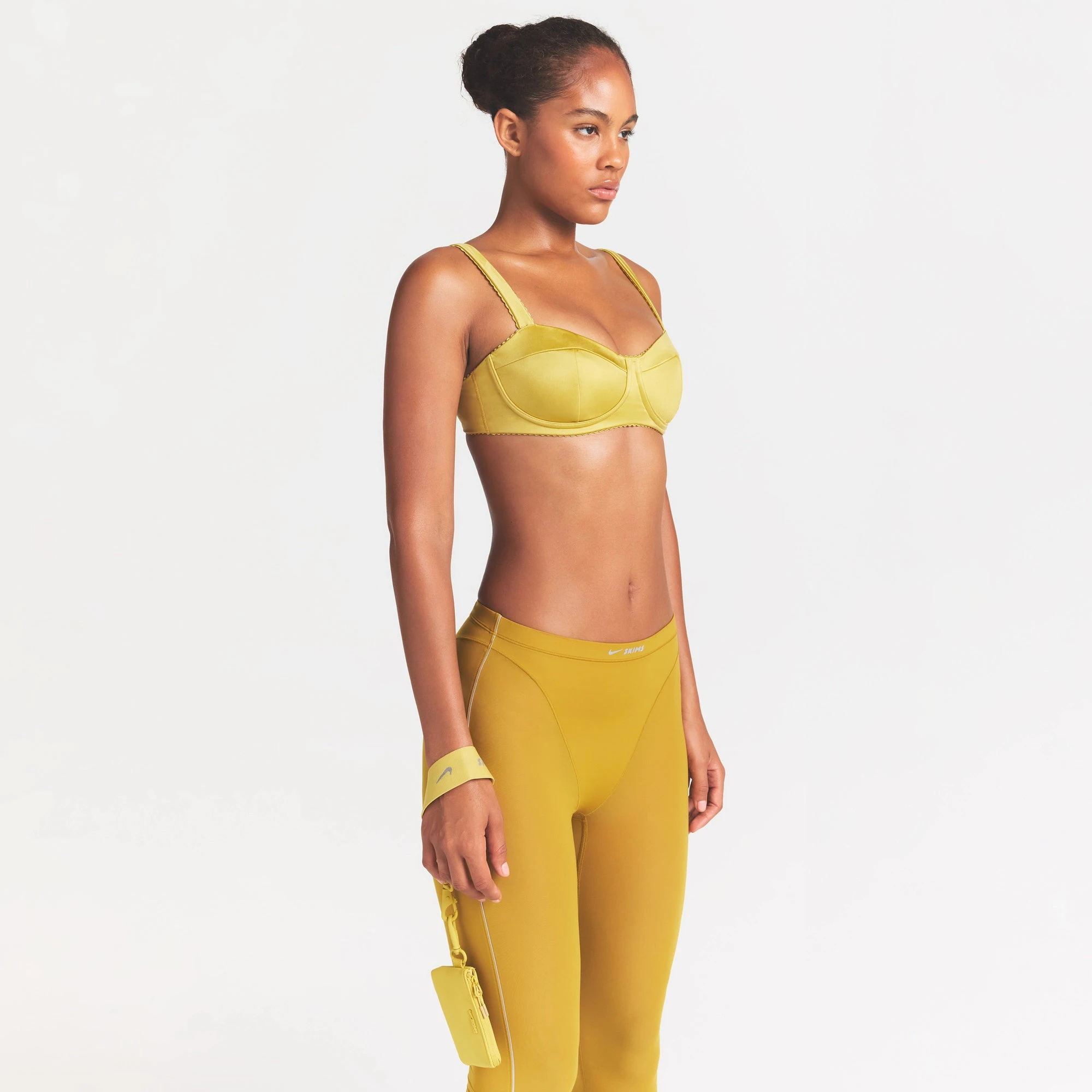 NikeSKIMS SATIN SHINE PANELED PICOT BRA | CITRINE ON A MODEL SIDE VIEW @ | FOCUS: 0.0, 1.0, 0.9